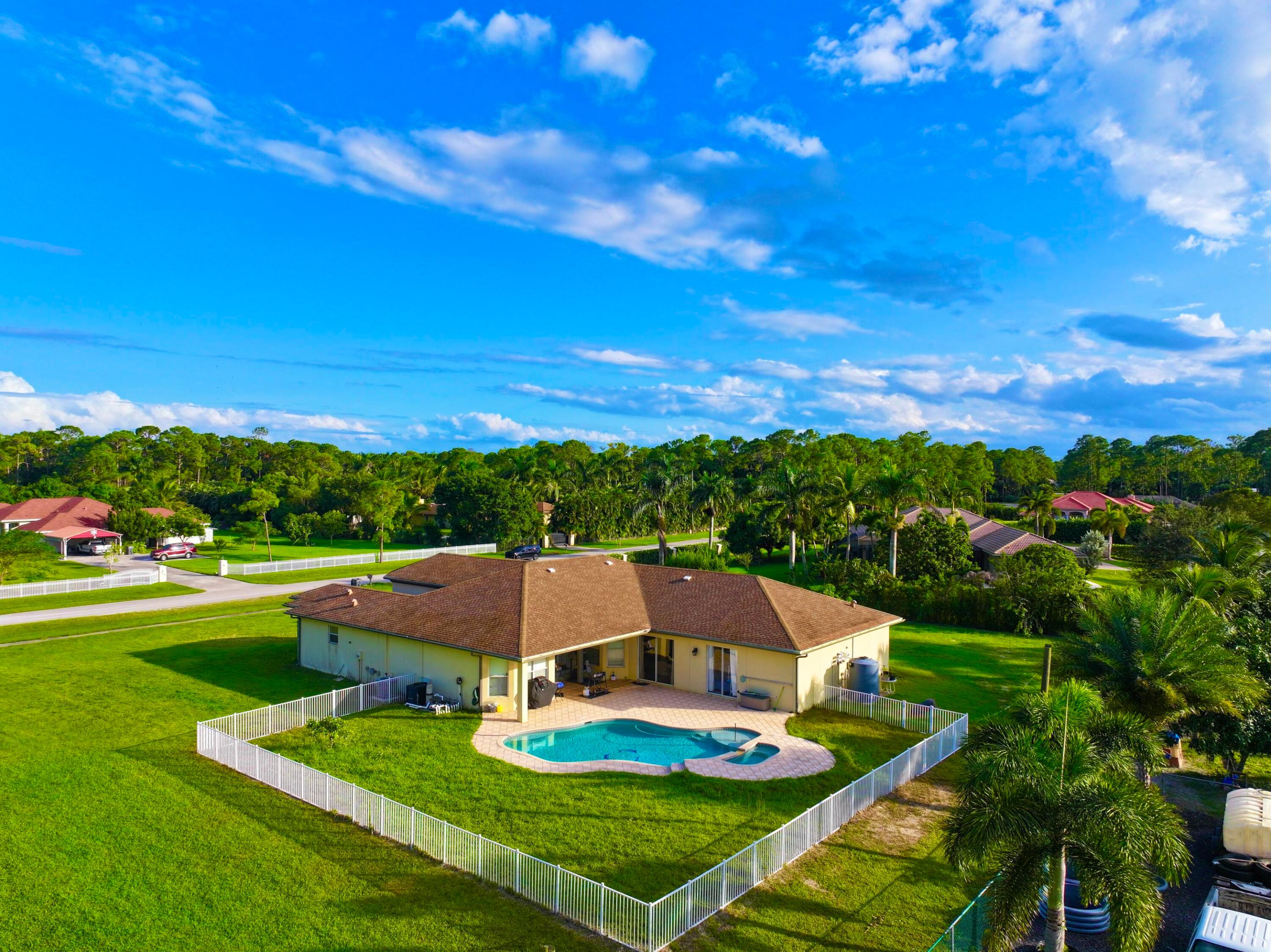 Rare opportunity !!!  MASSIVE HOME - IDEAL FOR ANYONE !!  Location **. Location **. Location ** !! no hoa !! 1.36 acres !!! 4865 total sq ft !! 7 bedroom 4 bathrooms 3 car garage , fenced pool with 2 master suites, lots of walk in closet space, and abundant natural light !!! WELCOME TO YOUR PRIVATE PARADISE IN THE HEART OF LOXAHATCHEE !! THIS STUNNING CUSTOM-BUILT ESTATE AT 6613 HALL BLVD PERFECTLY BLENDS MODERN COMFORT WITH SERENE COUNTRY LIVING ON A SPACIUOS 1.36-ACRE LOT !! SURROUNDED BY LUSH TROPICAL LANDSCAPING AND NICE HOMES- THIS PROPERTY OFFERS THE PEACE AND PRIVACY YOU'VE BEEN SEARCHING FOR - WHILE STILL BEING MINUTES FROM SHOPPING, DINING, AND TOP-RATED SCHOOLS. STEP INSIDE AND DISCOVER SOARING CEILINGS, AN OPEN-CONCEPT LAYOUT, AND ELEGANT FINISHES THROUGHOUT.  THE GOURMET KITCHEN FEATURES GRANITE COUNTERYOPS, STAINLESS STEEL APPLIANCES, WOOD CABINETRY, BAR TOP AND A LARGE ISLAND- IDEAL FOR ENTERTAINING !!! THE EXPANSIVE LIVING AREA FLOWS SEAMLESSLY TO THE OUTDOOR OASIS- COMPLETE WITH A COVERED PATIO, SPARKLING POOL, AND AMPLE SPACE FOR GATHERINGS OR RELAXATION UNDER THE FLORIDA SUN !!! THE PRIMARY SUITE IS A TRUE RETREAT, OFFERING A SPA-LIKE BATHROOM WITH DUAL VANITIES, A SOAKING TUB, AND A WALK-IN SHOWER. EACH ADDITIONAL BEDROOM PROVIDES GENEROUS SPACE AND NATURAL LIGHT. Enjoy no HOA restriction, allowing you to bring your boat, RV, or pets- this property truly embraces the freedom of loxahatchee living !!!! CLOSE PROXIMITY TO WESTLAKE, WELLINGTON, BEACHES, SHOPPING, AND WORLD-CLASS EQUESTRIAN VENUES !!! Experience the the perfect combination of Luxury, comfort, and tranquility. take this opportunity to to own one of Loxahatchee's most desirable properties- schedule your private showing today!!