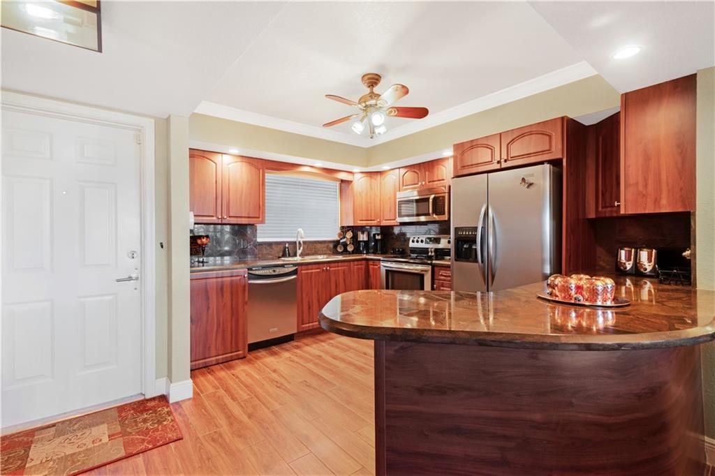 BEAUTIFUL UPGRADED 3RD FLOOR WATERFRONT PROPERTY WITH BAY WINDOWS OVERLOOKING THE INLET LEADING TO THE INTRACOASTAL. VIEWS OF LOVELY BAYVIEW HOMES, AND YACHTS PARKED OUTSIDE YOUR WINDOW. FLOORING IS TILE WITH WOOD LOOK THROUGHOUT. KITCHEN HAS UPGRADED KITCHEN CABINETS WITH GRANITE BACKSPLASH AND COUNTERTOPS AND STAINLESS STEEL APPLIANCES. DRYER IN KITCHEN. CROWN MOLDING THROUGHOUT. MASTER BATH HAS GLASS SHOWER WITH MARBLE TILE AND GRANITE COUNTERTOPS AND COPPER SINK. GUEST BATH HAS MARBLE TILE IN TUB.  ALL WINDOWS AND DOORS ARE HURRICANE PROOF. ALARM SYSTEM. BUILDINGS FRESHLY PAINTED. PRIVATE DOG PARK AND TIKI BAR AS WELL AS TWO POOLS. WALK TO THE BEACH. BUY YOUR BOAT A CONDO!! INTRACOASTAL AT END OF CANAL.  FANS AND CHANDELIER STAY.