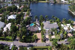 Behind its classical facade, this lovely waterfront home utilizes a mixture of tradition and modern design achieving interior spaces that are both stylish and comfortable.  The pool with marble decking overlooks the Intracoastal Waterway and a new 50 foot seawall dock and a new 45 foot finger dock.  Interior features include a renovated family room (2014) with outfitted wet bar offering idyllic views.  The kitchen has been updated with double wall ovens, natural gas cook top, solid wood cabinetry, granite countertops, and a new secondary refrigerator.  The living room has a wood burning fireplace and is adjacent to the formal dining room.  The property is sited on a large corner lot with extra large front yard.  The convenience of Atlantic Avenue and Delray’s famous beach is two blocks away.  Stunning opportunity for the most discerning buyer!