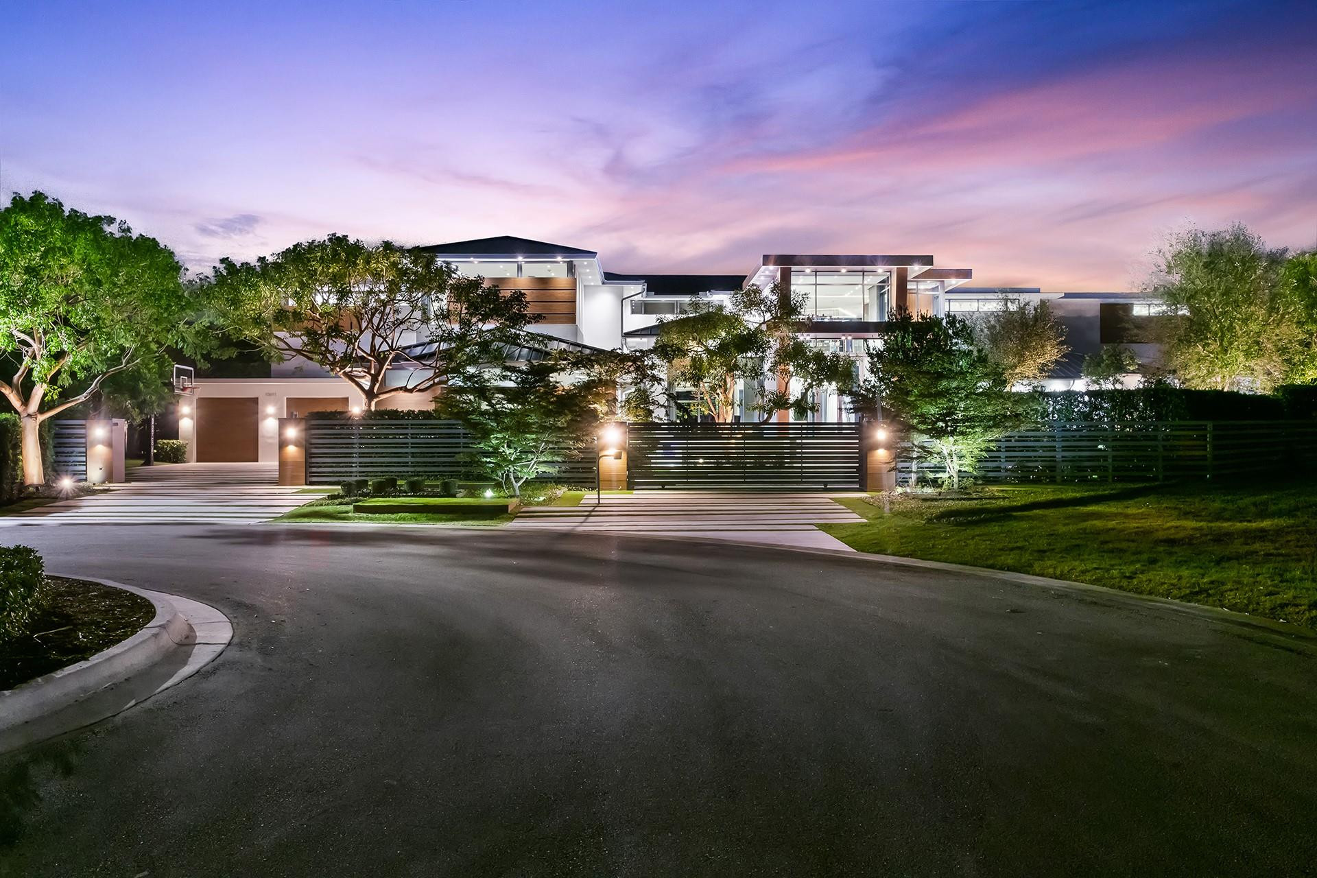 The most architecturally designed lakefront estate in the premier guard-gated community of Hawks Landing. Set on nearly an acre, this 17,400 sq ft modern residence captures light, water views, and glowing sunsets. The soaring 35-foot ceilings, dual floating steel staircases, and glass wine room define the interior. The Bulthaup kitchen opens through Nano doors to a resort-style 80' pool, waterfall, and expansive outdoor entertaining area with a full kitchen. The loft-inspired primary suite offers sliding oak doors and panoramic views. Some of the additional features include all en-suite bedrooms, a state-of-the-art gym, an 8-seat movie theatre, and a private guest house. Hawks Landing offers a clubhouse with a fitness center, tennis, pickleball, playground & 24-hour guard-gated security.