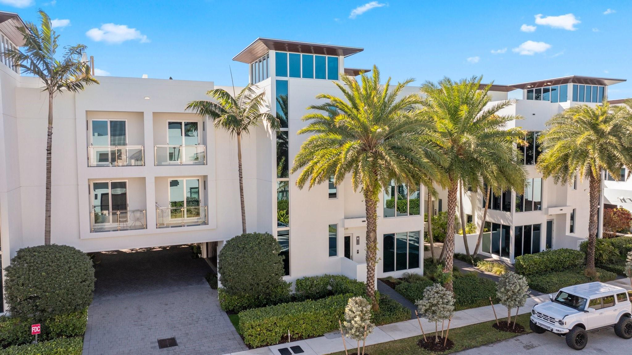 Exquisite ~3000 sf luxury three-story townhome crowned by expansive rooftop terrace w/360 ocean & city views! Floor to ceiling impact windows, ten foot ceilings & floating staircase masterfully blend modern elegance & coastal serenity provide the pinnacle of SoFlo lifestyle. Only 21 homes. Low HOA fees. Private elevator garage to rooftop. Custom Hacker cabinets, quartz countertops, Wolf gas top, Sub Zero fridge & Wine bar create chef's kitchen. Control4 system runs audio, lighting, temp, security. Four spacious ensuite bedrooms w/balcony. Hunter Douglas remote-controlled shadow blinds throughout. Concrete construction, Sprinkler system throughout & Generac generator. Only six minute walk to beach, music, shops, & dining. 2 Pets welcome. Private dock available to purchase. BRING ALL OFFERS