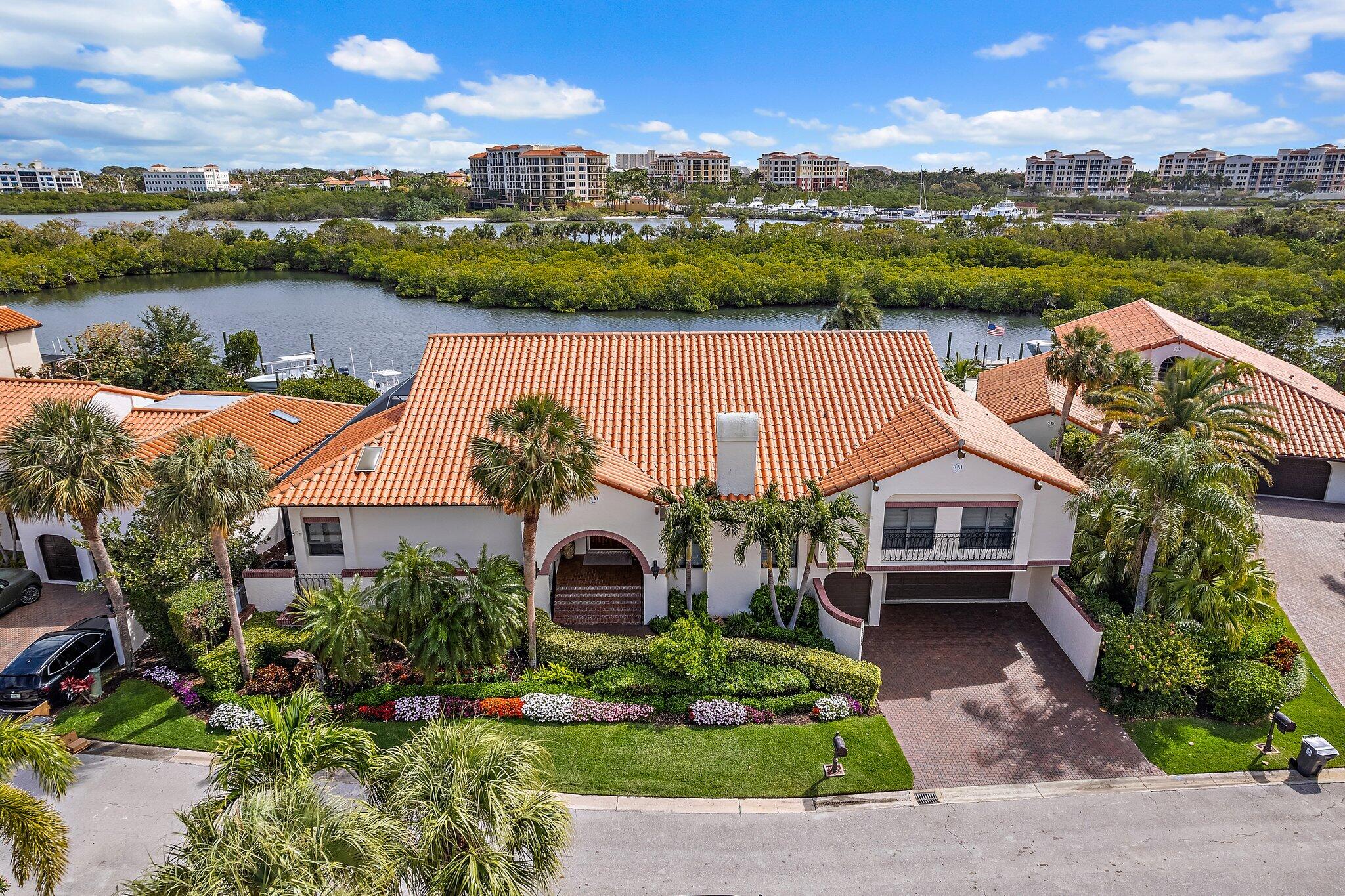 Spectacular 3 bedroom plus a private office/4th bedroom, 4 ½ bathroom waterfront home with a private pool, private dock and sensational saltwater views.  Home has a renovated interior, 3 newer AC systems, and impact glass throughout! This stunning home offers over 3,450 s.f. living space an expansive covered patio, a private screened refurbished pool/patio, and a private 75' dock on a protected waterway with Intracoastal access.  Elegant interior design features cathedral and volume ceilings, upgraded hard wood flooring, and upgraded finishes throughout!  Split floor plan design is complimented with entry level formal living and dining rooms, a renovated open kitchen with quartz countertops and custom cabinetry with an adjoining family room, and a private office/guest quarters with custom built-ins,  The master suite is also on the entry level and includes an en-suite bathroom, a large sitting room and access to the pool patio areas. The upper level offers two bedroom suites with en-suite bathrooms, volume ceilings, plush carpeting and ample closet space. Exterior features include an expansive covered patio with an adjoining screened/refurbished pool patio, and a private dock with access to the Intracoastal waterway.  There is also an attached two car garage and a golf cart garage.  This home is protected with impact glass throughout and has been impeccably maintained.  All sizes and fees are approximate