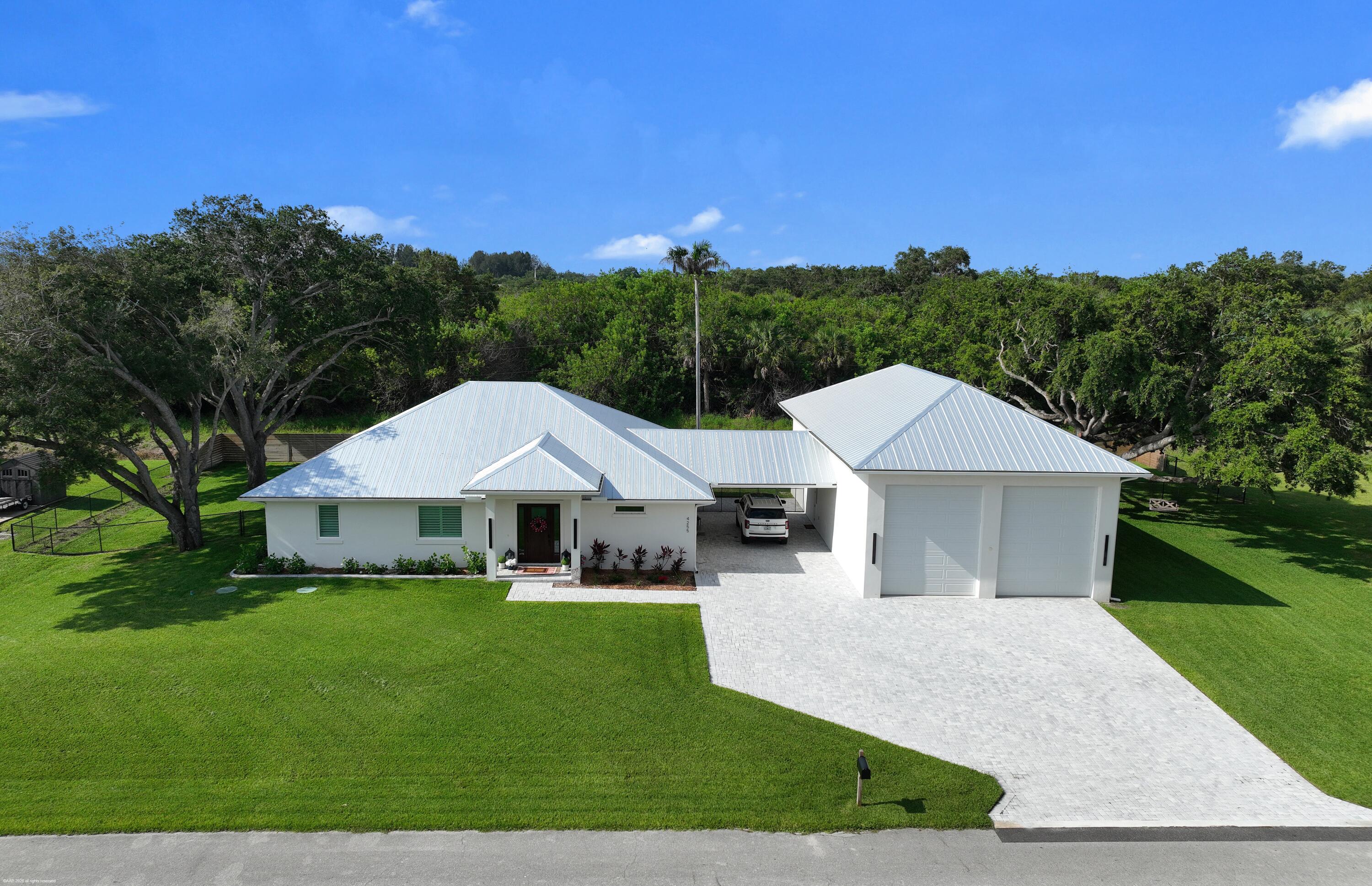 THE ULTIMATE COASTAL RETREAT! No HOA & room for every toy. Boasting a 4,680 SF footprint (2,000+ SF under air), 4255 79th Street is a custom 2025 estate offering a rare, highly desirable configuration of dual primary en-suites plus a 3rd full bath—perfect for luxury living, co-ownership, or guests. The crown jewel is the massive, attached 1,800 SF custom garage with 18-ft ceilings, 12x14 doors, a cedar loft, and 220V power, built to effortlessly house your Class-A RV, boats, or vehicle collection. Located just 2 minutes to the Wabasso Boat Launch. Inside, enjoy top-tier finishes, pristine modern design, and privacy flowing to a spectacular backyard oasis and pool. Pristine dual-suite privacy meets a world-class custom toy barn. Low-maintenance high-end living. Tour today!