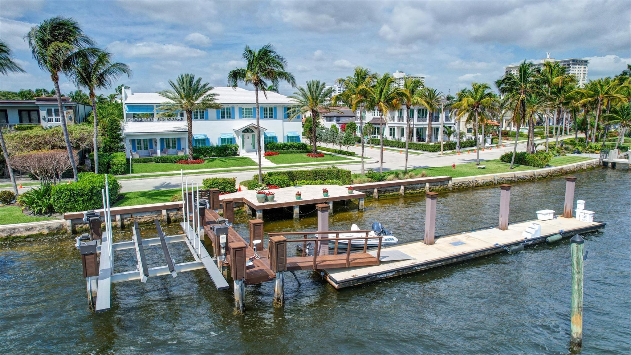 Newly built custom Intracoastal Estate offers a daily boat parade with wide open Intracoastal views from many rooms. Superbly located in highly desirable, security patrolled Idlewyld, close to beaches & Las Olas. Barely occupied, shows impeccably & as-new! Sophisticated island inspiration, high quality construction, millwork & natural finishes, hardwood floors & unique marbles. Lutron technology. Ultimate Chef's kitchen, professional grade appliances. 1st level: media, living & dining areas, 6th bed suite/home office option. Upstairs 4 bedrooms + ultra-luxury Primary Suite, dual closets/spa baths. The sale price included the vacant lot next door. There was also a furniture allocation and other factors that affected the recorded sales price. - Additional lot is INCLUDED.- All outdoor patios, walk ways and pool surround are Shell Reef brushed limestone. Handcrafted glass mosaic tiles in the pool and spa that has a wall fountain feature.- Saltwater pool with stepping stone and beach ledge water features.  Pool side gas fire bowl feature, retractable electronic awning and separate spa.  Dedicated cabana bathroom.- Kitchen countertops are Taj Mahal honed & leathered quartzite.  Backsplashes Ann Saks.  Professional grade appliances includes La Cornue gas range, Sub-zero fridge and freezer plus two dishwashers.  Large center island perfect for casual dining.- Downstairs en-suite potential bedroom, office or media area.- Large two car garage has custom cabinetry and storage.- 2nd level Primary Suite is the perfect retreat.  Private access to the large covered terrace which is perfect for capturing the intracoastal views in privacy.  Enjoy the vaulted ceilings and island ambiance!  There is also a private exterior staircase offering access to the pool.- Primary Suite includes two separate spa style bathrooms finished with statuario marble, custom cabinetry and tiles. Two large dressing rooms and morning bar.- Two of the secondary bedroom suites have access to a private stairway down to the pool and lawned additional lot.- The intracoastal waterway bedroom suite has an incredible spa style bath with soaking tub and separate shower.- The laundry and utility room is on the second level.- Air conditioners include: #1/5 ton, #2/3 ton, #3/2 ton, #4/3 ton and 2 mini splits in the family room plus 1 mini split in the garage.- Idlewyld Security has two elements, the Idlewyld Improvement Association maintains the gate and center island.  There is also private security patrol overnight.- Low tide depth at the dock is approximately 7 ft and there are 5 ft boater's set backs & 30,000 lb boat left.  Multi yacht dockage potential to put a larger yacht on the outside dock, tender on the lift and additional smaller boat or water toys on the inside of the floating dock.  All privately gated._ New construction by top builder, Jim La Vallee Construction, Fort Lauderdale.  The custom detailing and quality of this residence must be seen to be appreciated.