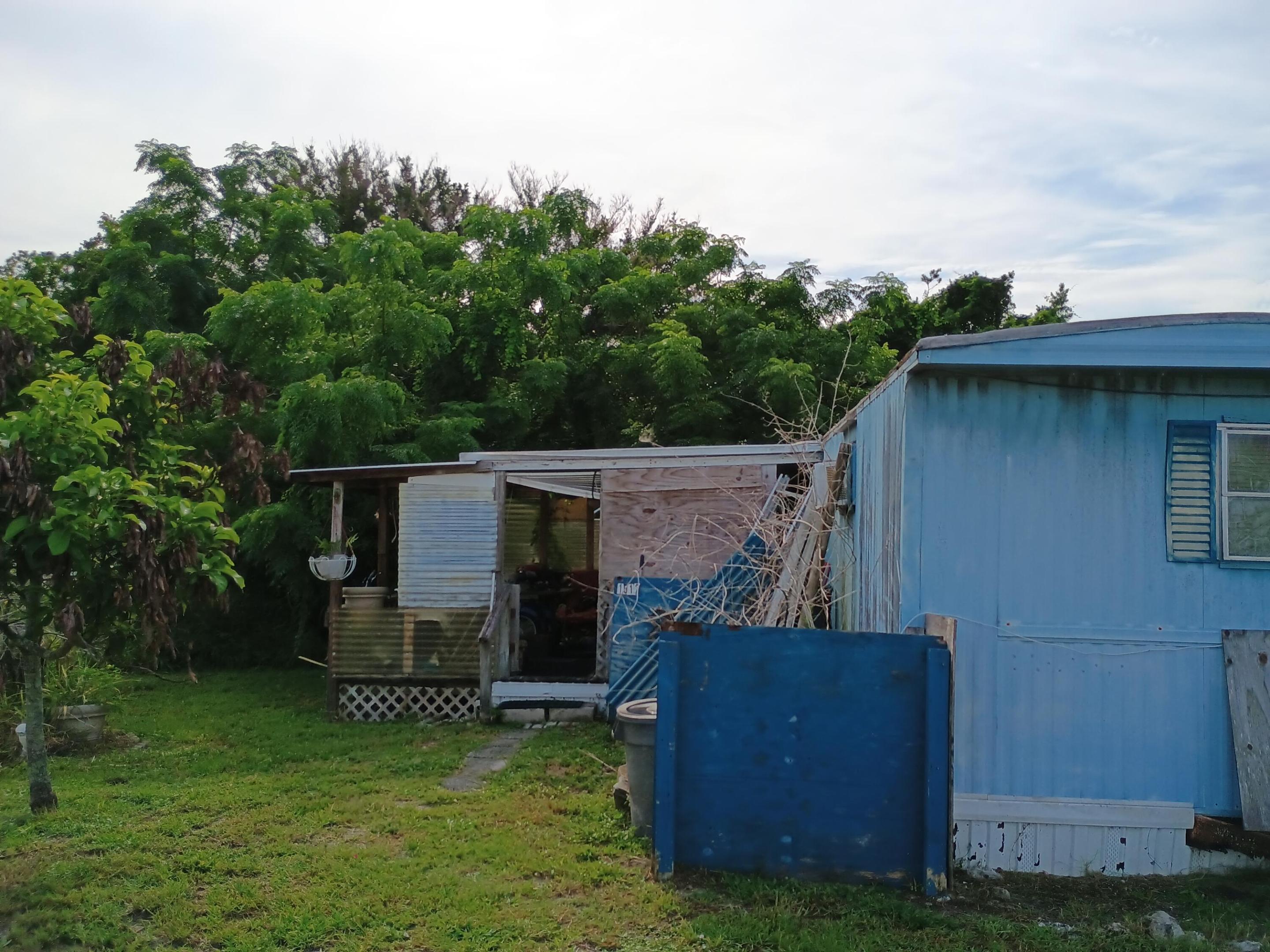 Mobile home in poor condition being sold as-is, with the price based primarily on the value of the lots. Property includes 4 lots totaling approximately 0.23 acre, offering a rare opportunity for redevelopment, storage, or future replacement housing. The existing mobile home needs significant repair and is best suited for an investor, or buyer looking for a land-value purchase.  The lot configuration gives added flexibility and extra space beyond a standard single parcel. Great chance to secure a property with multiple lots in place and room to re imagine the site. Buyer to verify all dimensions, utilities, zoning, and allowable use. Property on paved road at end of dead end street.