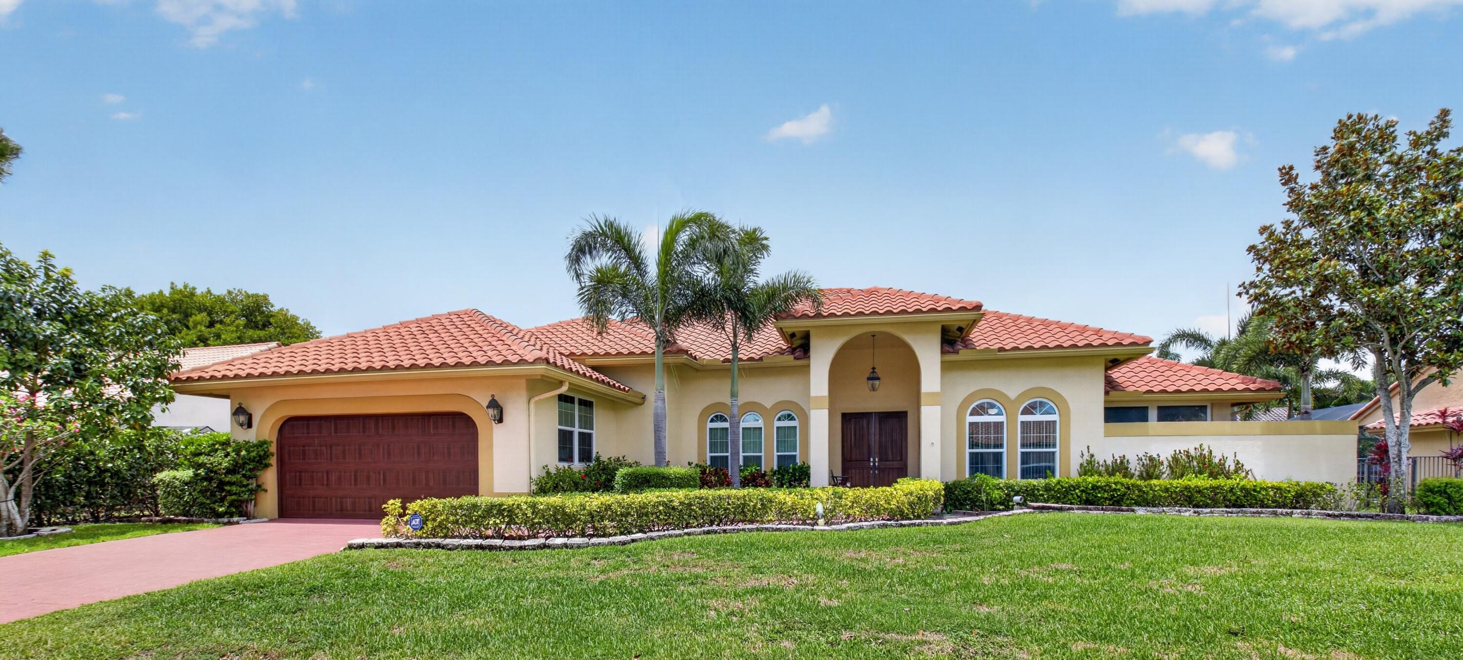 Welcome to your private central Boca Raton oasis. This stunning single-story residence, just under 3,000-square-foot, perfectly blends modern open-concept living with classic Florida charm. The dramatic vaulted ceilings and rich hardwood floors create an immediate sense of airy sophistication. The thoughtful split-bedroom floor plan ensures maximum privacy, separating the spacious primary suite from the guest bedrooms. Perfect for hosting, the home boasts formal living and dining rooms, alongside an expansive kitchen that flows seamlessly into the family room.  The heart of the home opens directly onto a spectacular outdoor paradise. A massive, screened-enclosed pool deck and covered patio offer the ultimate year-round indoor-outdoor lifestyle. Perfect for festive gatherings .  The property features full impact-glass windows and doors, incredible storage solutions, and a spacious 2-car garage. Situated in a highly desirable neighborhood with top-rated schools, you are just minutes away from upscale shopping at the Town Center at Boca Raton, with rapid access to both I-95 and the Florida Turnpike.