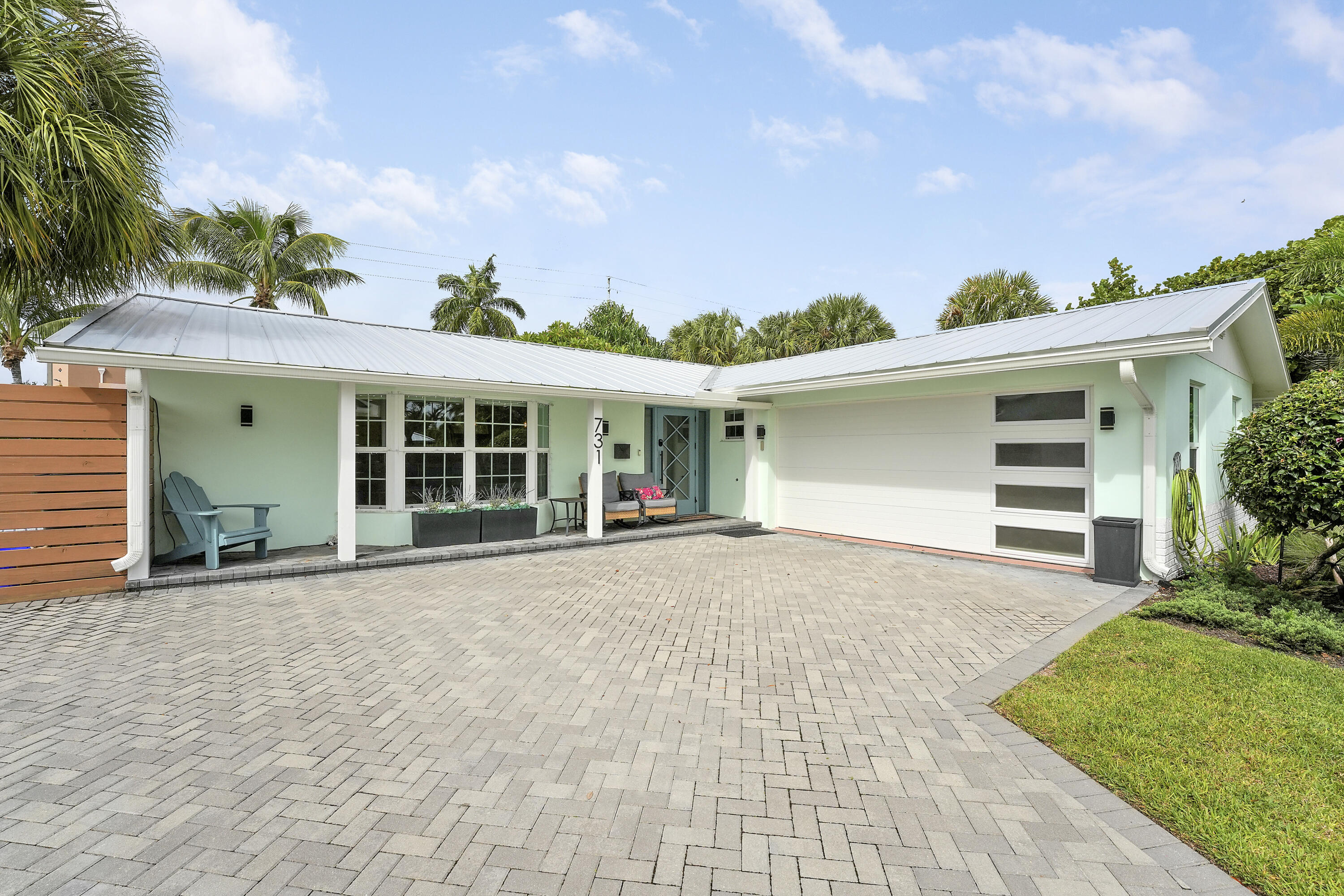 Welcome to a truly exceptional home where timeless design, quality craftsmanship, and modern luxury come together in one of North Palm Beach's most sought-after neighborhoods. Filled with natural light and featuring a desirable split-bedroom floor plan, this completely reimagined residence showcases high-end finishes and meticulous attention to detail throughout.  Every major component of the home has been thoughtfully updated, allowing you to move in with complete confidence. Renovations include a new metal roof (2021), spray foam Icynene insulation for exceptional year-round energy efficiency, in-wall sound insulation, all new mold and moisture-resistant drywall, custom cabinetry, beautiful new flooring, designer appliances, all new plumbing and drain lines, completely updated electrical system, dual new air conditioning systems with commercial-grade ductwork, impact-rated windows and doors, a stunning custom front entry door, insulated impact garage door, Rinnai tankless gas water heater, new natural gas service for the range, dryer, and water heater, a new sprinkler system and pump, and so much more.  Step outside to your own private backyard retreat featuring a beautifully renovated swimming pool with new decking, plaster, waterlines, and equipment. Brand-new turf and lush tropical landscaping are complemented by a 10-foot privacy hedge, while a newly constructed 8-foot alley privacy wall (2026) creates an exceptionally secluded outdoor oasis.  Beyond the home itself, enjoy everything that makes North Palm Beach one of South Florida's most desirable places to live. Walk just two blocks to Lakeside Park and its waterfront beach, or take a short stroll to the local library, Anchorage Park and Marina, tennis courts, playgrounds, and boat ramps. Residents appreciate the Village's dedicated police department, nearby fire station, tree-lined sidewalks, valet trash service, walking mail delivery, and the welcoming sense of community that makes this neighborhood so special.  This is more than a home—it's a rare opportunity to own a virtually brand-new residence in the heart of North Palm Beach, where luxury, convenience, and the Florida lifestyle come together perfectly.