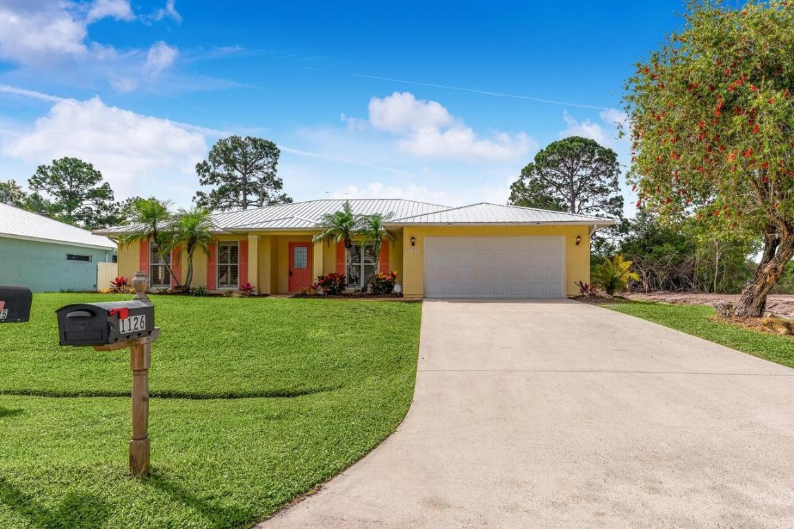 BRAND NEW METAL ROOF 2022! Spacious, well-maintained 3-bedroom (possible 4th bed), 2-bath, 2-car garage home located in a lovely, family -friendly neighborhood close to everything PSL and Fort Pierce has to offer. Features include new landscaping, entry level living area with formal dining room, screened-in porch overlooking the spacious backyard w/ room for a pool, stainless steel appliances, plantation shutters, roman tub & shower in master bath, plenty of closet space, sliding glass doors opening to backyard and patio, and much more! Located on a quiet street and convenient to US-1. Walking distance to schools, a 5-minute drive to shopping and restaurants, and 15-minute drive to the ocean. No HOA Fee's. Newer A/C (2018 or 2019 owner believes).
