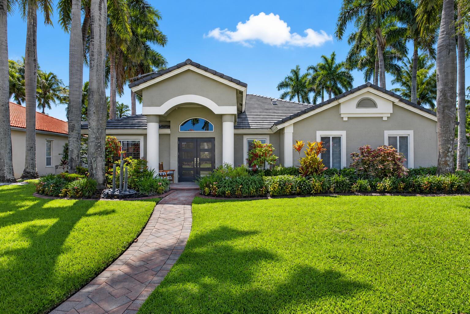 Welcome to the home you've been waiting for in Wellington, FL! This impeccably reno'd 3BR/2BA/2CG lakefront residence on .34 acres, offers luxury living w/ no expense spared. Features include a 2019 tile roof, impact windows & doors, stunning 28" tile, a designer island kitchen w/ quartz c-tops, S/S appliances, & beautifully reno'd bathrooms w/ premium finishes throughout. Enjoy serene lake views from the hurricane-rated picture-screen lanai w/ desirable eastern exposure, + a custom outdoor kitchen, tropical landscaping, and professional landscape lighting. Additional upgrades include motorized  blinds in MBR & FR, EV charging outlet, Remy Halo HVAC air purifier & laundry rm w/ washer, dryer, cabs & sink. Located in one of Wellington's most desirable communities near top rated schools,  parks, shopping, dining, equestrian venues, and world-class polo facilities. Welcome home to gated Binks Preserve!