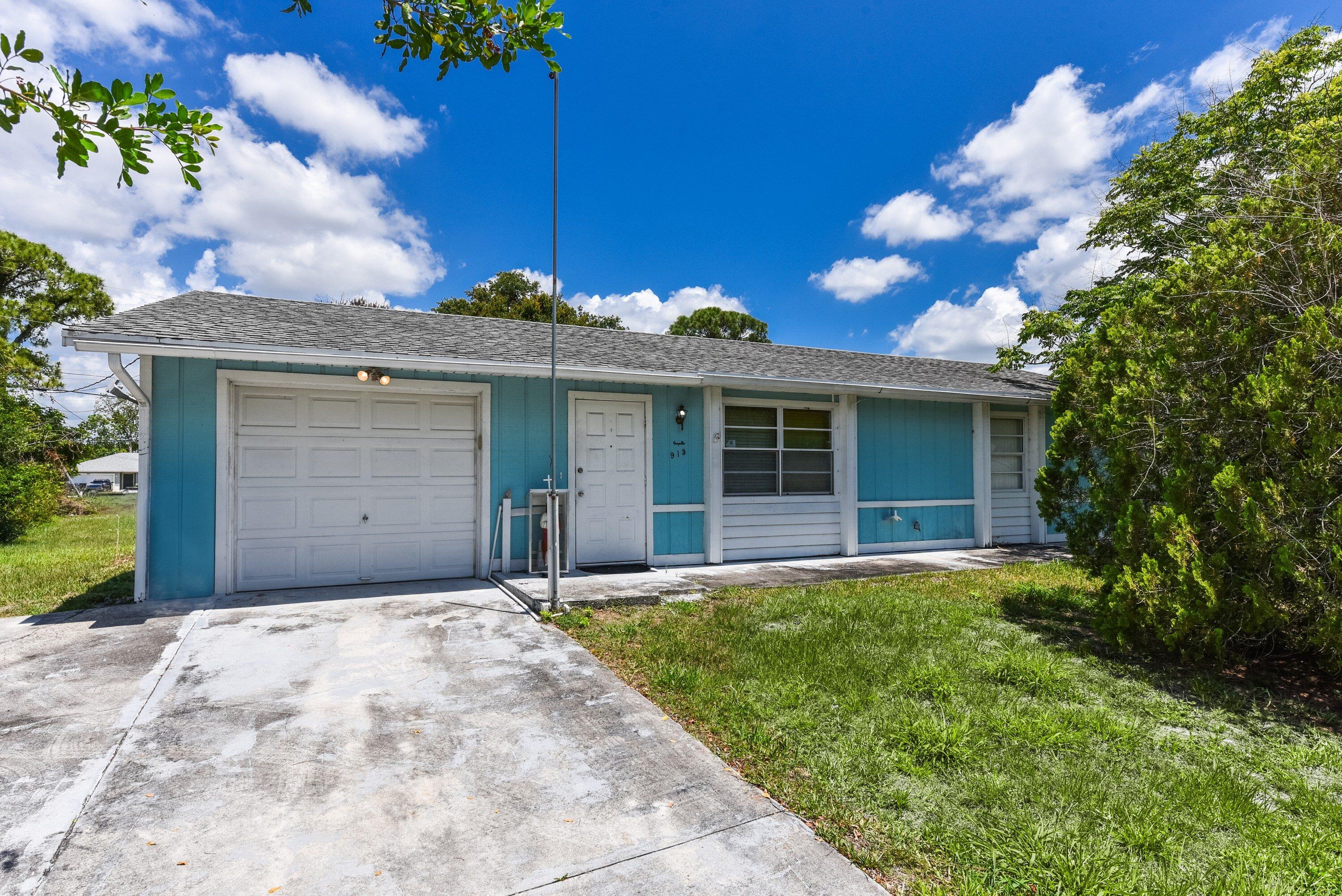 Opportunity knocks with this 2-bedroom, 1-bathroom handyman special located in a prime, central Port St. Lucie neighborhood. This home is the perfect canvas for an investor or a creative homeowner looking to build immediate equity and truly make a space their own. Featuring a functional layout with a 1-car garage, the property sits on a nice big yard that offers plenty of room for outdoor living, gardening, or future expansion. The exterior includes a patio for relaxing and a convenient storage shed for your tools and equipment. While the home requires updating and attention—including a 2004 roof and visible wood rot on the exterior—the potential is undeniable. Bring your vision to 915 SW John Maccormack and take advantage of this fantastic renovation opportunity! With its proximity to  local parks, shopping, and dining, this property is perfectly positioned for someone looking to plant roots or add a high-potential asset to their portfolio. Homes at this price point in such a convenient location are rare—bring your contractor and explore the possibilities today!