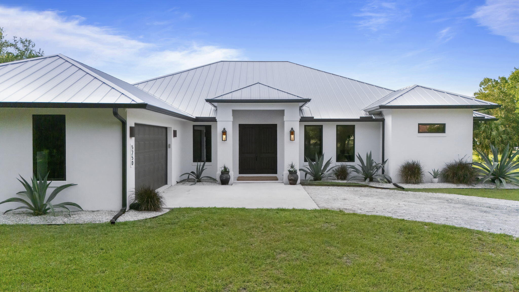 Coming Soon! Stunning 5 bed 3 bath 2023 Custom Home on 5 Private Acres. Peaceful country living with beach proximity. Discover the perfect blend of luxury and serene country living in this stunning home complete with modern finishes and energy-efficient design. Settle into your great room and soak in unobstructed, tranquil views of nature from sunrise to sunset. Bring your horses and livestock! Ideal location, just 11 miles from the beach, so you can enjoy ocean breezes and coastal living. Shopping, dining, and everyday conveniences are just minutes away, giving you the best of both worlds. Whether you're looking for a private family estate, a hobby farm, or a peaceful forever home, this rare opportunity checks every box. Schedule your private showing today! Owner Agent. Room measurements approximate, buyer to verify.   Set on 5 private acres behind a gated flag-lot entrance, this custom-built 5 bedroom, 3 bathroom estate blends modern luxury, smart-home technology, and refined farmhouse living. Overlooking a stocked pond and open pasture, the home was thoughtfully designed for both everyday comfort and effortless entertaining. A stunning chef's kitchen anchors the living space with a 48" Bluestar gas range, dual dishwashers, quartzite island, custom cabinetry, and walk-in butler pantry. Expansive impact sliders open seamlessly to the outdoor living area, creating a true indoor-outdoor lifestyle experience. Built with exceptional attention to quality and efficiency, the property features CBS construction, standing seam metal roof, foam insulation, whole-home reverse osmosis system, Lutron smart lighting automation, business-grade WiFi, security camera system, generator hookups, propane infrastructure, and impact-rated windows and doors throughout. Outside, the land is equally impressive with a stocked ¾-acre pond, artesian well, island retreat with hot tub, multiple electrical service panels, and infrastructure already suited for animals, gardening, recreation, or future expansion. A rare opportunity to enjoy luxury living with the freedom and privacy of country life.  See home specs in document attached.
