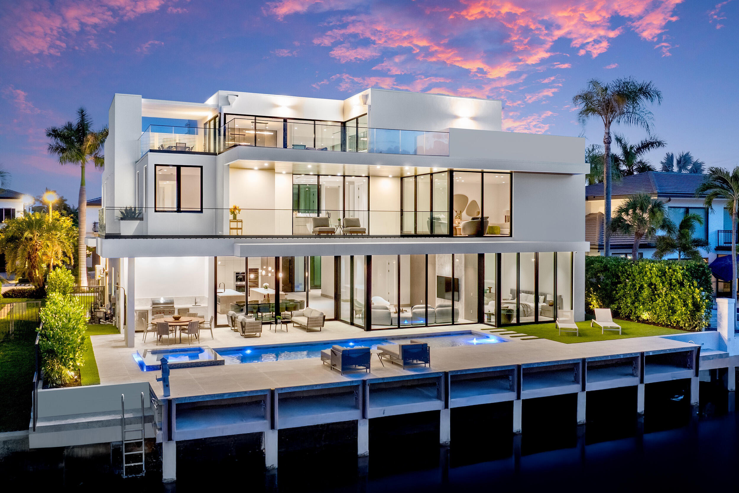Exceptional Value - just reduced by $750,000.00. Brilliantly staged in Boca Raton's prestigious Golden Harbour enclave, this newly completed three-story estate by Empire Development redefines luxury waterfront living. Encompassing nearly 10,000 square feet of indoor-outdoor living space within a secure, gated setting, this architectural triumph showcases Empire's signature originality. From world-class finishes to unmatched amenities and a coveted location, every detail of this designer residence embodies modern elegance at its finest.
Now complete and ready for its discerning owner, 541 Golden Harbour Drive is a newly unveiled masterpiece offering an unparalleled living experience defined by exceptional scale, masterful detail, and timeless luxury. Set on an expansive 85-foot waterfront lot just minutes from Lake Boca, with no fixed bridges, this residence is a haven for yachting enthusiasts and connoisseurs of waterfront living.
Spanning 7,898 square feet of refined interiors and 9,169 total square feet across three elevator-accessible levels, this rare three-story estate is bathed in natural light and showcases sweeping views of the water and skyline. Each level unveils a new layer of luxury, culminating in a one-of-a-kind third floor, a blank canvas for creativity, wellness, or private retreat.

The home's design blends contemporary elegance with functional sophistication. Towering 32-foot glass walls welcome you into a soaring foyer, offering a dramatic sense of arrival. Throughout the residence, glass expanses blur the line between indoors and out, framing lush tropical landscaping and tranquil water vistas.

With five bedrooms, seven full bathrooms and two powder rooms, the estate features a palatial 1,500-square-foot primary suite that redefines indulgence. Dual spa-inspired bathrooms and spacious walk-in closets complete the sanctuary.

The chef's kitchen is a showcase of exquisite craftsmanship, fitted with custom stonework, sleek cabinetry, and top-of-the-line Wolf and Sub-Zero appliances. A hidden secondary kitchen and laundry room are discreetly tucked behind matching millwork, enhancing both beauty and functionality.

Every surface and material has been meticulously curated. Oversized 4' x 4' Italian porcelain tile defines the main level, while a sculptural floating staircase in white oak leads to upper floors adorned in the same rich wood tones, seamlessly tying the living spaces together.

Outdoors, a resort-style pool and spa provide the perfect backdrop for relaxation and entertaining. The three-car garage, with hurricane-rated glass doors and high ceilings, accommodates up to six vehicles with the addition of lifts.

Located in Boca Raton's coveted Golden Harbour community, residents enjoy easy access to South Florida's most exclusive amenities, including beaches, golf courses, Red Reef Park, and the world-renowned Boca Raton Resort & Beach Club. Nearby Mizner Park and Royal Palm Place offer fine dining, upscale shopping, and cultural destinations.

This is more than a home, it is Empire Development's latest triumph in architectural artistry and a rare opportunity to own a statement of contemporary coastal luxury.