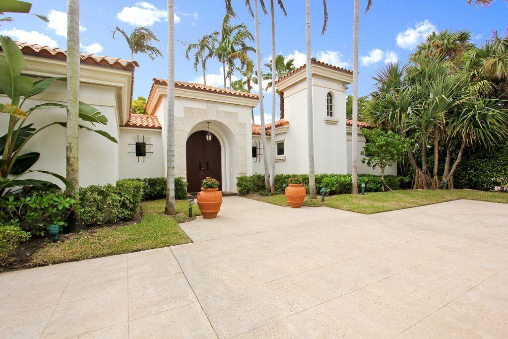 This unique Mediterranean in town estate provides a beautifully private enclosed sanctuary.
This home is open and inviting from the second you approach the private entrance. As you enter this walled,enchanted, sanctuary you are taken back by the beautiful views of the heated swimming pool and gracious covered loggia and gardens.
This custom built home,with built in audio speakers and professional landscape lighting make this home magical day or night.
A lovely screened lanai overlooks the serene gardens just outside the formal living room. Three on suite bedrooms, including an engaging, beautiful master suite with large custom  closets and a gorgeous marble bathroom, plus a private separate cabana/guest house suite with basic kitchen features, and a private entrance make this a very easy home to live and entertain in.The very generous  over sized 3 car garage and whole house generator complete this extraordinary opportunity to own this beautiful estate on a very quiet street just a block from the beach and Intracoastal lake path.
This amazing property is just minutes from the Breakers, 5 Star restaurants, clubs,and all that Palm Beach has to offer.