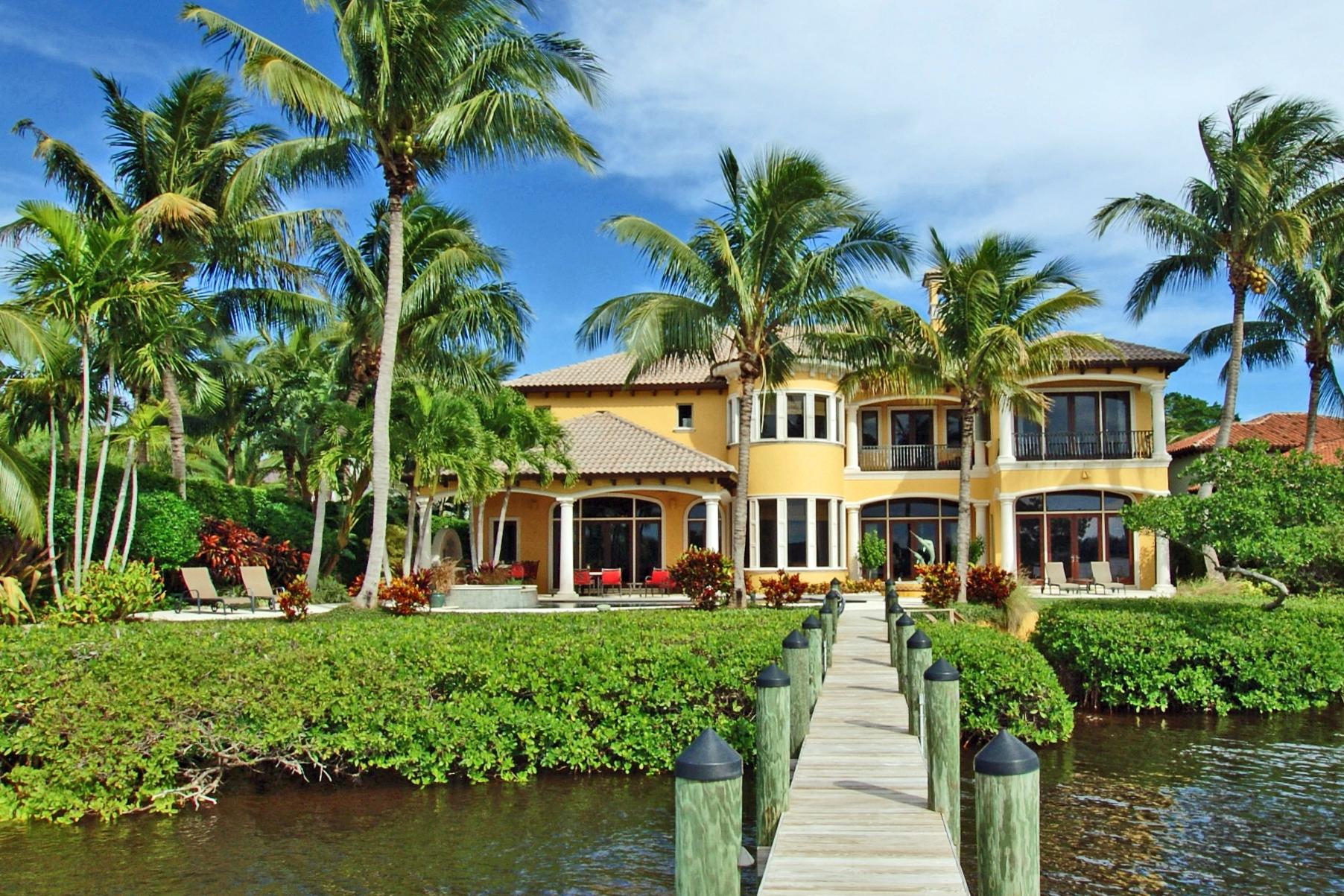Discover the beauty of the Loxahatchee River from this quality built ''Neandross'' home. Located on a private point lot with SE exposure, this home offers spectacular, panoramic river views. With nearly 6,500 square feet of living space, this home includes 5 bedrooms, 5 full baths, 2 offices, an exercise room, club room and 2 laundry rooms. The William Oh kitchen offers a large pantry, an ice maker, beverage cooler, warming drawer, Miele steamer and a 285 bottle wine storage. Additional popular features include Leed's custom woodwork/cabinetry, impact glass doors/windows and a 25kw generator. There's plenty of air conditioned storage space including a fishing locker, attic storage and the 3-car garage. The outside setting features a spacious lanai with sound system, summer kitchen, salt water pool with gas/electric heaters, paddle board storage, private dock with two 12,000 lb. boat lifts and white sand beach access. Enjoy the day's end in the outdoor spa watching the incredible sunsets over the scenic Loxahatchee River.