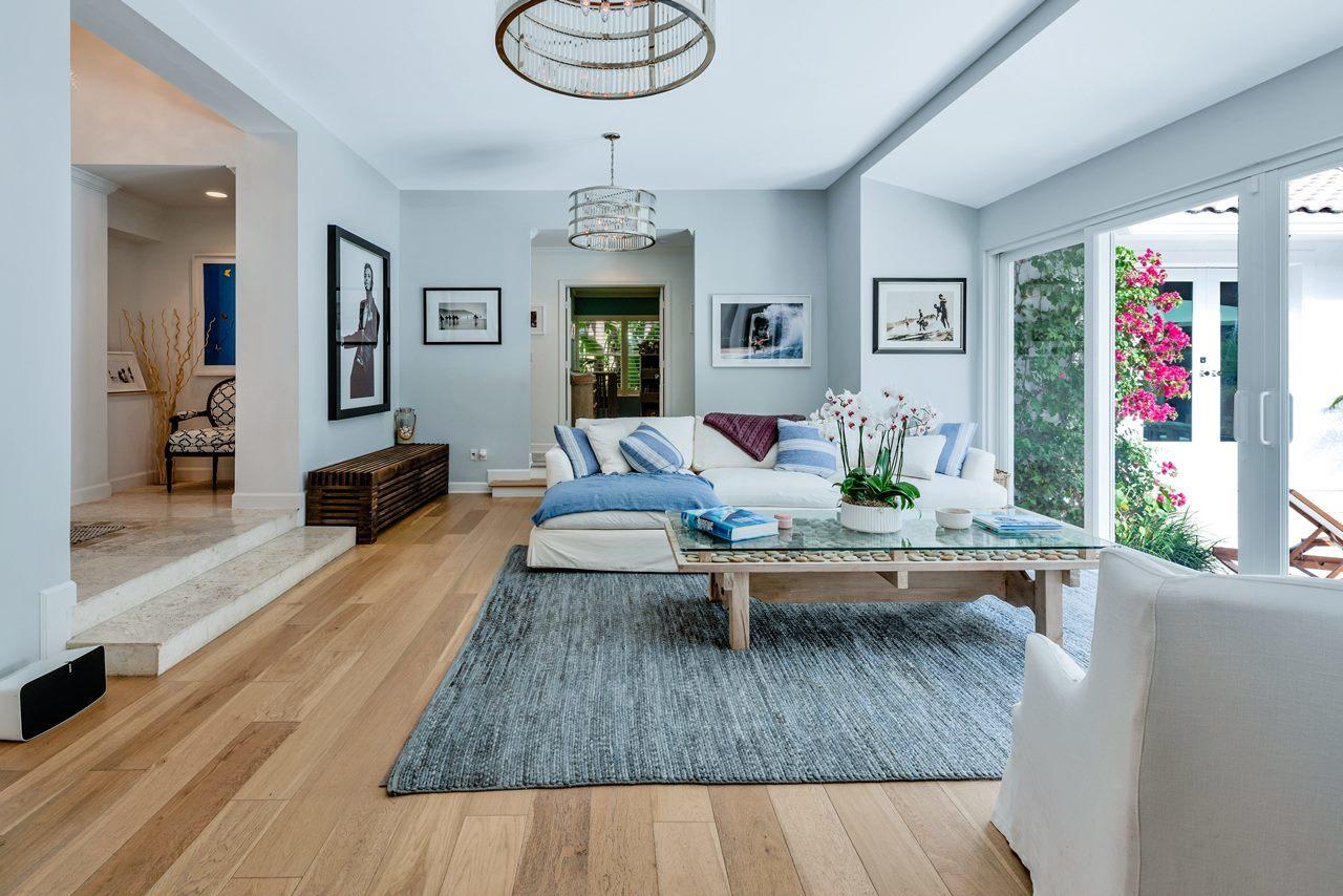 Beach Chic Oasis in the North End! • Unbelievable Quality Renovation • Light + Airy 4 bedroom, 3 bath • Marble + Hardwood Floors Throughout • Impact Glass Throughout • Lush Landscaping • Heated Saltwater Pool • In-Home Gym • Beach Access • Convenient Lake Trail Access