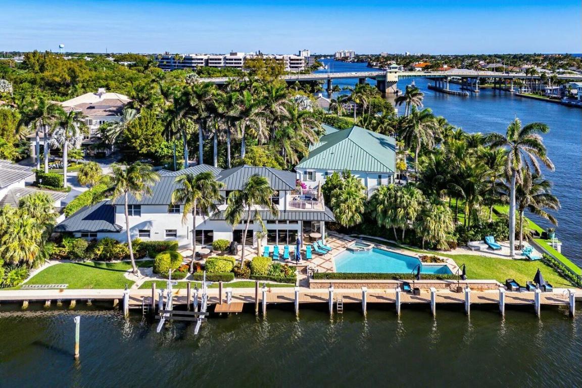 Welcome to your private tropical oasis on a prime corner lot. This exquisite single-family home offers breathtaking canal and Intracoastal views, making it a true paradise for boating enthusiasts with direct ocean access. Designed for seamless indoor-outdoor living, the residence features a resort-style pool and spa surrounded by generous entertaining spaces. Inside, discover a thoughtfully designed layout that includes a first-floor primary suite, a private gym, an open-concept chef's kitchen, and a dedicated office area—perfect for both relaxation and productivity. Ideally located just steps from the Plaza at Delray and only minutes from Atlantic Avenue, Mizner Park, and the beach, this home blends the best of waterfront living with unbeatable convenience.