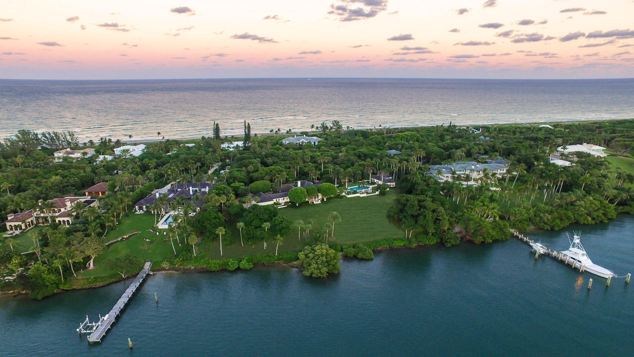 Rarely does a property become available in all of south Florida that can compare to 430 S Beach on Jupiter Island. Designed by pre-eminent architect, Marion Sims Wyeth, the 4 bedroom main house and 3 bedroom guest house on 4.4+ acres sit on one of the Island's highest elevations and are surrounded by expansive terraces and a glistening pool. 366' of Intracoastal frontage provide glorious, unobstructed views across the water to a ''forever natural'' sanctuary. Deep water will accommodate a large yacht and unfettered access to the ocean minutes away. Included in the property is a 10' beachfront parcel which grants the owner deeded right to ocean access. Lush landscaping and old growth trees create complete privacy and seclusion. Jupiter Island building regulations will permit additions or new construction up to 18,000 sf. ft. 
The convenient south end location ensures a quick connection to mainland shops and restaurants, Palm Beach and airports.
