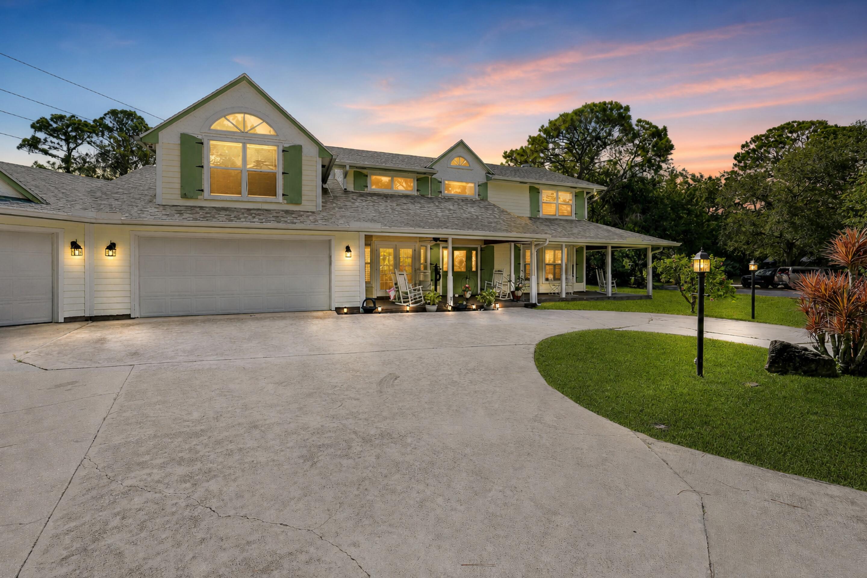 YOUR FLORIDA LIFESTYLE AWAITS in Imperial Woods: a rare opportunity for private one-acre living east of I-95 in the heart of Jupiter. Picture morning coffee on the balcony, evenings on the 75+ foot wraparound porch or beside the fire pit, and weekends entertaining around the screened 32-foot pool. Set on a pie-shaped cul-de-sac lot, this 3,700+ sq. ft. custom home offers 4 bedrooms, 4 bathrooms, a recently updated kitchen, an oversized 3+ car garage, an above-garage guest suite and a primary suite with balcony access. A 2020 roof and two newer A/C systems (2020/2025) add confidence. Double-gate backyard access accommodates a boat or RV, while a concrete sports court and future guest-house potential, subject to approvals, offer space to live, gather and play without sacrificing location. Inside, natural light fills a thoughtfully designed floor plan with formal living and dining rooms, a separate family room, a recently updated kitchen with breakfast nook, and a sizable upstairs loft ready to adapt as a lounge, study or creative space. The kitchen's passthrough window makes serving the outdoor entertaining spaces effortless, while French doors throughout create a seamless connection between the interior, porches and balcony.  Three of the four bedrooms open through French doors to an outdoor living area, and each bedroom enjoys convenient access to a full bath. The main-level suite includes a walk-in closet and private bath that also serves as the pool's cabana bath. Upstairs, the 300+ sq. ft. primary retreat features an ensuite bath, walk-in closet and direct balcony access. A second ensuite bedroom also opens directly onto the balcony. Separately, the 250+ sq. ft. guest suite above the garage offers vaulted ceilings, generous closets and a private bath—creating a comfortable, independent retreat for extended stays, recreation, a substantial home office or game room.  Outdoor living continues in a screened gazebo-style nook—an inviting setting for dining, conversation or a quiet afternoon. The concrete sports court offers a flexible canvas for basketball, pickleball, fitness and recreation, with select listing images illustrating possible configurations. Propane serves the fireplace, with an additional connection available for a grill or future summer kitchen.  Public water and sewer add everyday convenience, while a zoned sprinkler system helps maintain the acre homesite. Nearly 1,000 sq. ft. of garage space provides exceptional room for vehicles, tools, hobbies, equipment and the gear that comes with the Florida lifestyle.  Imperial Woods is a well-kept enclave of only 47 custom estate homes, distinguished by private roads, mature trees, abundant wildlife and minimal through traffic. Access to sought-after Jupiter-area public schools further strengthens the location.  Enjoy exceptional proximity to everything that defines the Jupiter lifestyle—approximately five minutes to central Jupiter, seven minutes to I-95 and twelve minutes to the beach, with Riverbend Park, Jupiter Medical Center, shopping, dining, golf, boating and miles of blue water nearby.  Some homes simply provide an address. This one offers the freedom to spread out, welcome the people you love and shape a lifestyle that is entirely your own. Experience its scale, privacy and possibilities in person—schedule your private showing today.  All measurements, travel times and MLS information are approximate and not guaranteed. School assignments and ratings should be independently verified. Guest-house and other improvement potential is subject to zoning, permitting, HOA requirements and all other applicable approvals. Some listing images have been virtually staged or digitally modified to illustrate potential uses of interior and exterior spaces; these images are conceptual and may not depict existing conditions or improvements.