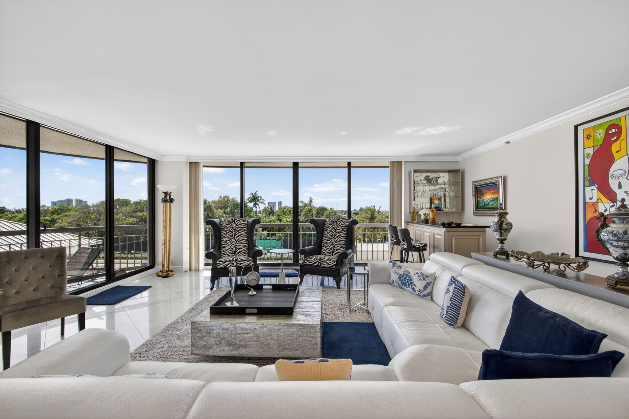 Enjoy this beautiful open floor plan with ceiling to floor Impact Glass Windows throughout. Balconies off of every room to enjoy the sunsets and sunrises.  An open kitchen with snack bar, eat in kitchen nook plus a large formal dining space, this feels like a home. Two large bedrooms with 3 full baths and 1 half bath plus private laundry. The master bedroom is private and spacious, with 2 separate bathrooms and 2 walk in closets. The exceptional amenities include two heated swimming pools with all new decking, elevated hot tub, two fully equipped fitness centers, sauna, two tennis courts, bocce court, residential barbecues, luxurious owners' lounge, billiard room, full library and private resident poolside restaurant. The Martinique II offers a totally carefree lifestyle with private beach access, twenty-four-hour concierge services in each tower a manned guard gate entry with twenty-four-hour security plus garage parking.