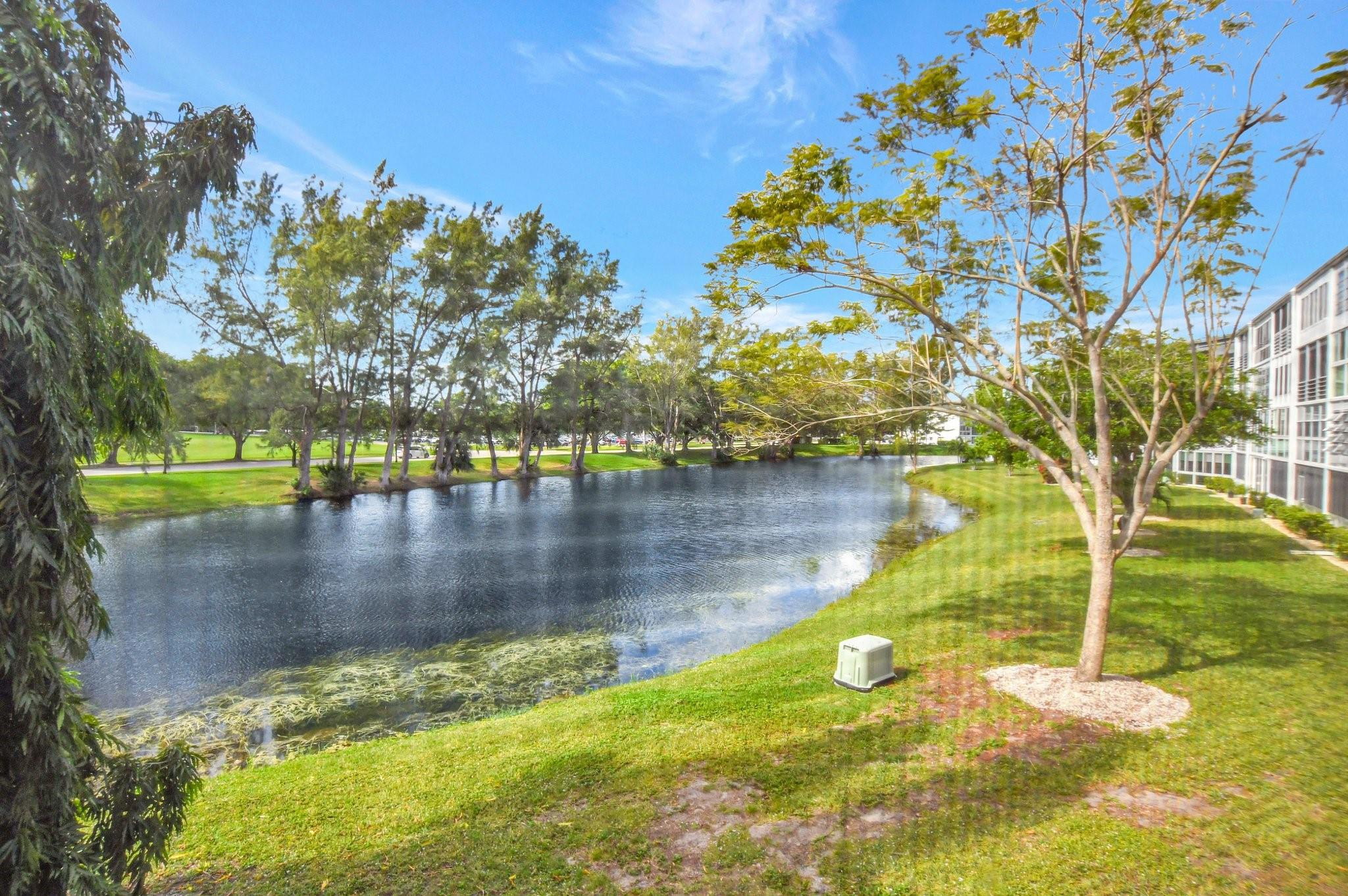 STUNNING remodeled 1 bdrm, 1.5 bath condo with a GORGEOUS LAKE VIEW & walking distance to the clubhouse! This fabulously appointed unit boasts HURRICANE IMPACT DOORS & WINDOWS, vinyl waterproof flrs, new electrical panel & new Bath fitter shower stall w/glass drs in primary bathrm. The galley kit features granite cntrs, induction stove, gorgeous cabinets & recessed lighting, all drws & doors EASY CLOSE & pantry w/upgraded shelving! Exquisitely furnished & ready to move in. Enjoy your morning coffee from the encl patio with new solar shades..overlooking a beautiful waterview! Well maintained & financially stable bldg. Gated comm w/24 hr sec, pools, tennis, pickleball, Clubhouse w/gym, billiards, theater, cafe, classes, clubs & more! Close to shopping, beach & restaurants! Assoc Claims 55+