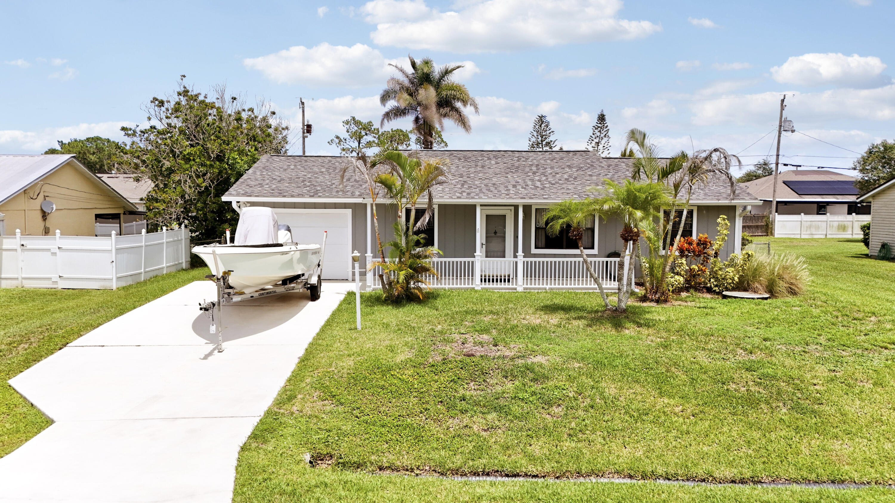 Discover this charming 2Bd, 2Ba Single Family home. Centrally located in the non-HOA Gatlin Pines area of PSL and move in ready. Featuring a split floorplan where each bedroom has it's own dedicated bathroom. Comfortable living and dining area with wood look tile flooring.  Updated kitchen with granite counttertops, S/S appliances and breakfast bar.  Converted single car garage with large utility room for household or recreational storage and separate laundry area. Enjoy quiet mornings and shady afternoons on the covered and screened porch overlooking a large fenced backyard.  Additional separate open paver patio for grilling or relaxing by the fire. W/H 2024.  Roof 2018.