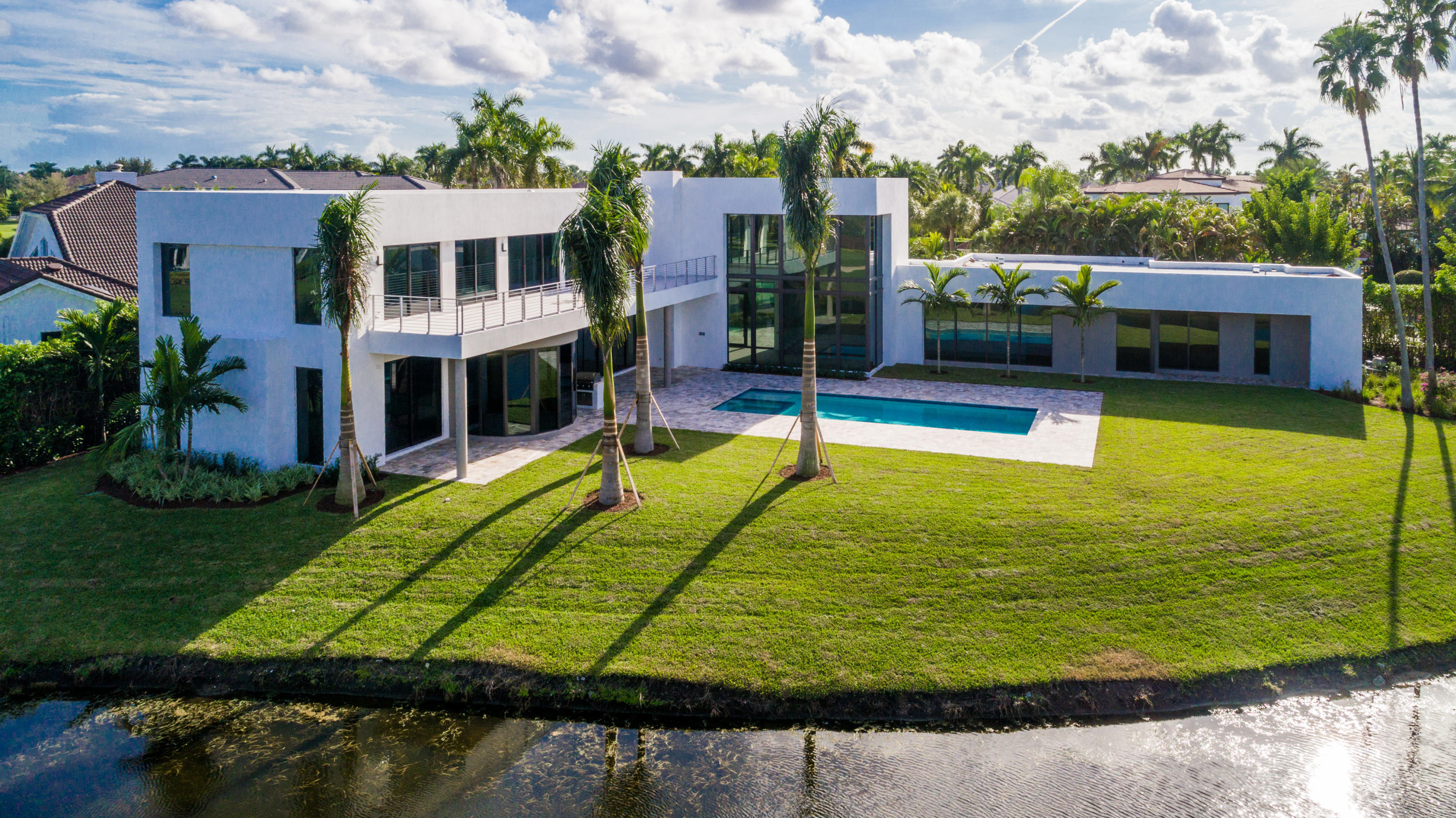 New Construction. Luxury and sophistication define this contemporary estate. This strikingly elegant residence with 7180 sq ft of living area features magnificent architecture and exquisite custom finishes throughout, beautiful ceiling treatments, and porcelain tile floors. An open concept living area create the ultimate atmosphere for grand living. Other features include a luxurious master suite with his and her imported marble baths, 1st floor media room and office, and a gourmet chef's kitchen featuring state of the art appliances. Just off the kitchen a light filled large family room and breakfast area overlook lake and golf course views, a dramatic resort style pool, and covered loggia with summer kitchen. Control 4 system and hurricane resistant impact windows and doors. The information herein is deemed reliable and subject to errors, omission or changes without notice. All measurements are approximate.