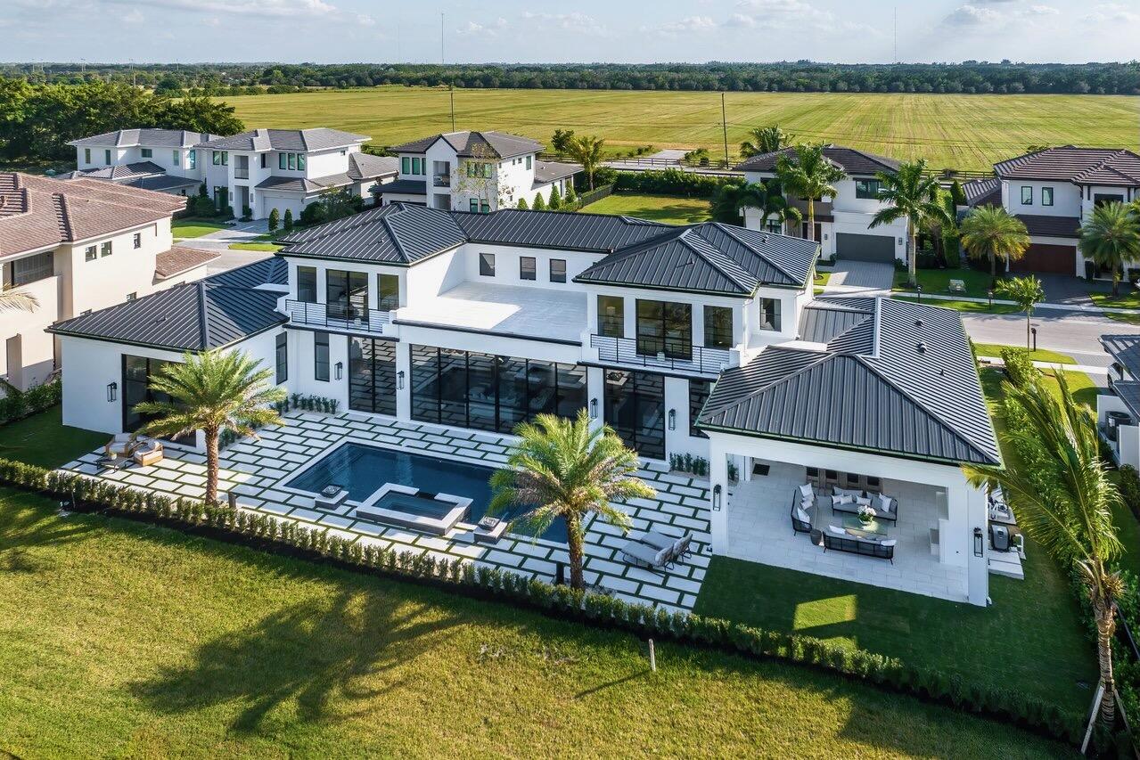 Beautifully appointed BRAND NEW custom home on a DOUBLE lot in the sought after neighborhood of Blue Cypress in Palm Beach Polo Cub. This home boasts over 6,000 sq ft. with exquisite views of the unobstructed 92 acre preserve. The precision of architecture and immaculate detail in this warm contemporary meets modern property will take your breath away! With a total of 5 bedrooms and 6.5 baths, the first floor impressive master has FULLY private his/her baths and custom closets. There is an independent study, full outdoor kitchen with fireplace, expansive pool and jacuzzi as well as views down the 10th fairway of the Cypress Golf Course. The second floor offers 4 bedrooms, including 2 VIP suites with adjoining baths, one of them features a wet room complete with a soaking tub and shower. The masterful kitchen is complete with chef grade appliances and an expansive pantry. Uniquely complemented by a private secondary kitchen to allow for behind the scenes preparation! Laundry on both first and second floor, elevator optional and much more!