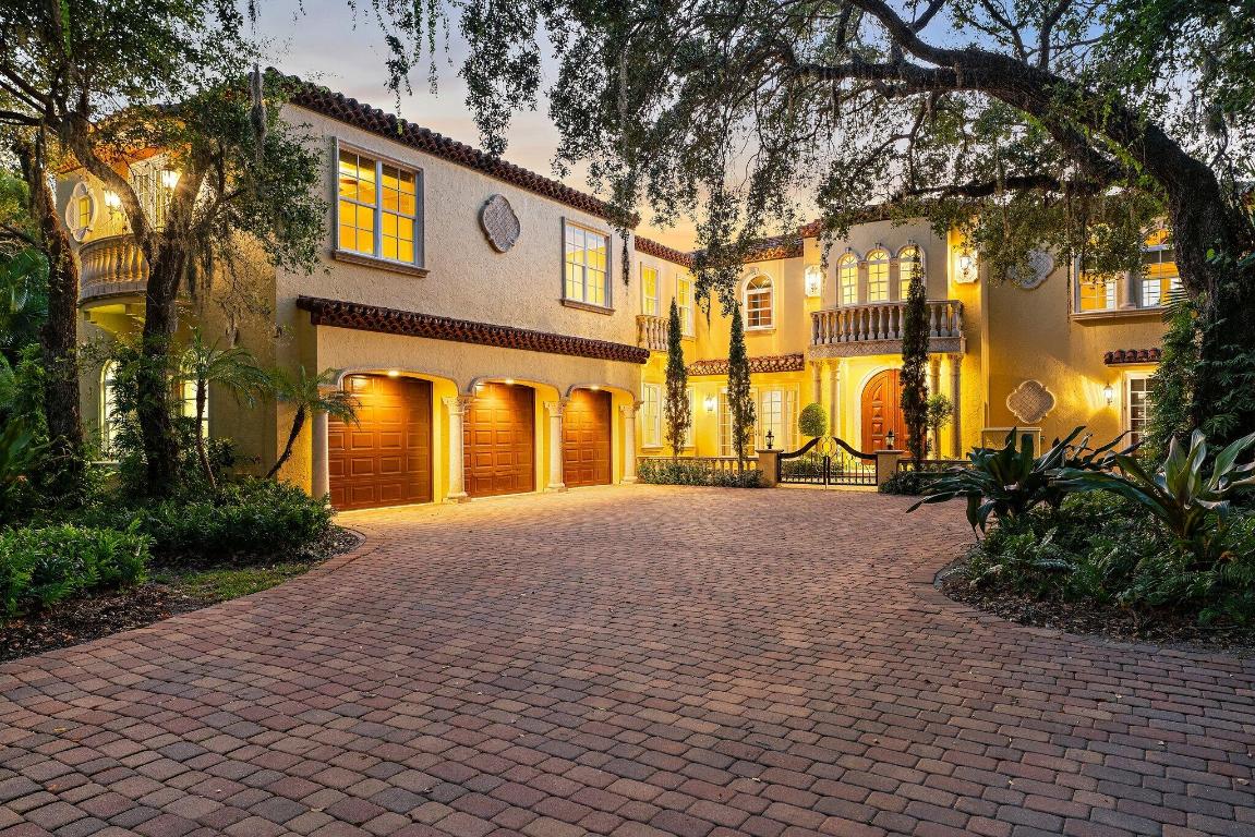 Spectacular Riverfront Property with Deep Water Access for Large Vessels! Minutes from the St Lucie Inlet, this Mediterranean-inspired estate offers premier dockage with dual slips, boat lift, wide-water views, and a newly re-planked dock with covered pavilion. Through private gates, be transported to Tuscany as cypress and mature oaks frame Villa Loggia, blending Old World elegance with modern comfort. Inside, enjoy a grand open kitchen and family room with walls of windows, a richly appointed mahogany office, and a temperature-controlled wine room. Upstairs, retreat to a expansive primary suite with dressing room, while ensuite guest rooms enjoy a private living area. An elevator adds convenience.