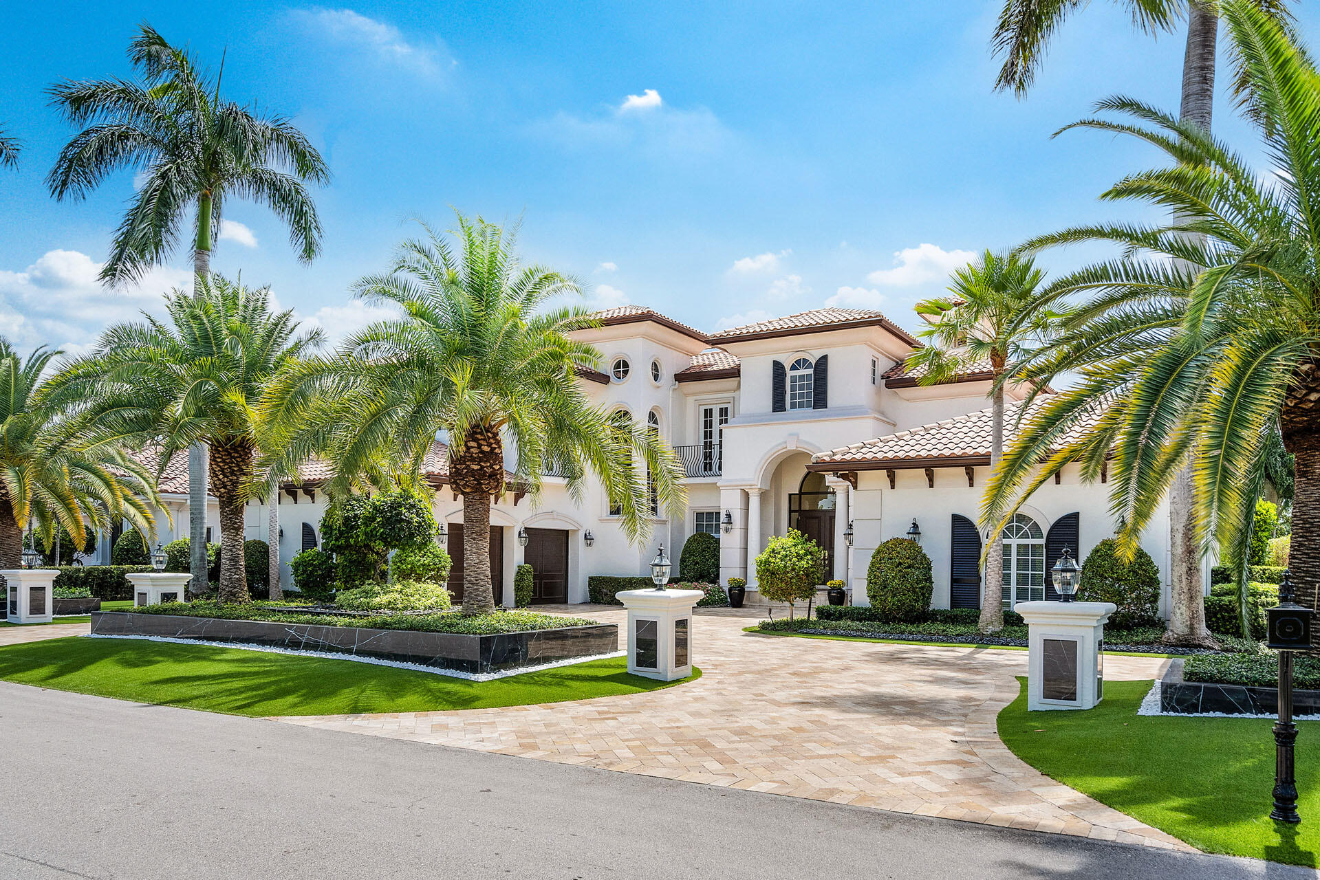 Inviting, bright, and refreshed. Seamlessly blending contemporary style with timeless architectural details and designer finishes, this 5-bedroom home has a 5,800 sf open floor plan with incredible golf views! The motorcourt driveway services an exceptional split 4-car garage while welcoming guests to a covered entry with wood double doors. Inside, guests are greeted by the living room with a gorgeous fireplace, elegant dining room, handsome office with custom wood built-ins, and spacious family room opening to the chef's kitchen for inclusive gatherings. The first-floor primary suite has stunning pool views, dual walk-in closets, and a spa-like bath w/ glass shower and soaking tub. Live the premier lifestyle among Jack Nicklaus' vision of world-class golf in sunny South Florida with resort-style amenities in your backyard. Take a dip in the refreshing pool with cascading spa, then enjoy the open and covered patio seating areas and built-in BBQ. The gated backyard is appointed with panoramic views of the broadest section of the 6th fairway and is beautifully landscaped for total privacy.