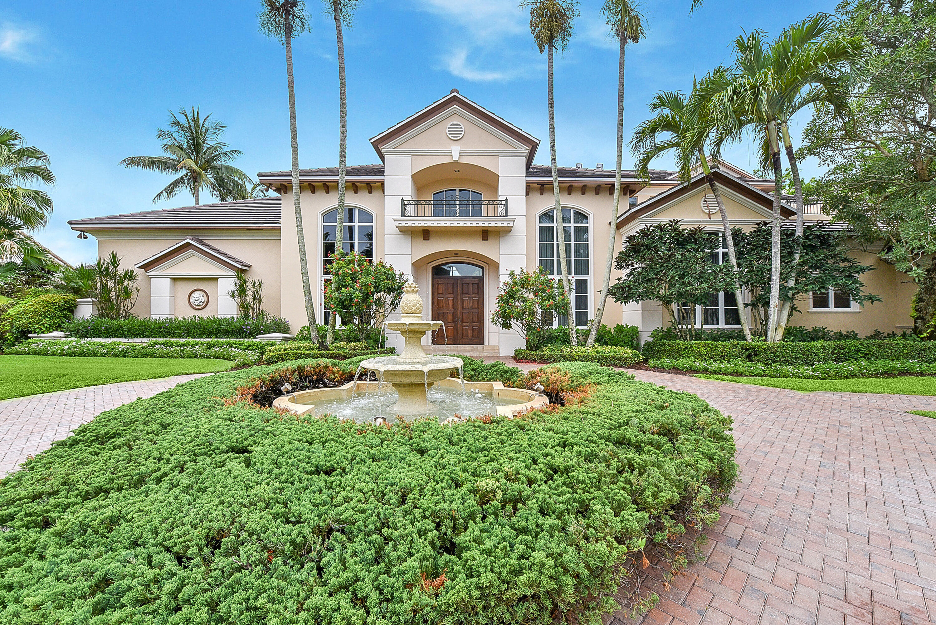 This luxurious Palm Beach inspired estate with over 7,700 sq ft of living area is situated on over ½ acre lot and enjoys spectacular lake and golf course views.  Featuring magnificent architecture and quality custom finishes throughout the first floor offers a stunning living room, dining room, rich wood paneled library, gourmet chef's kitchen, large family room, home theater, luxurious master suite with his and her bathrooms and sitting room and en-suite guest bedroom.  The second floor offers an entertainment area, 3 large bedrooms with adjoining baths, 2 private balconies with stunning views.   A lushly landscaped resort-style pool, spa, kitchen and loggia offer the upmost in entertainment and complete this estate. Additional features include 4 car plus golf cart garage, generator, new roof 2020 and hurricane impact windows.  The information herein is deemed reliable and subject to errors, omissions and changes without notice. All measurements are approximate.