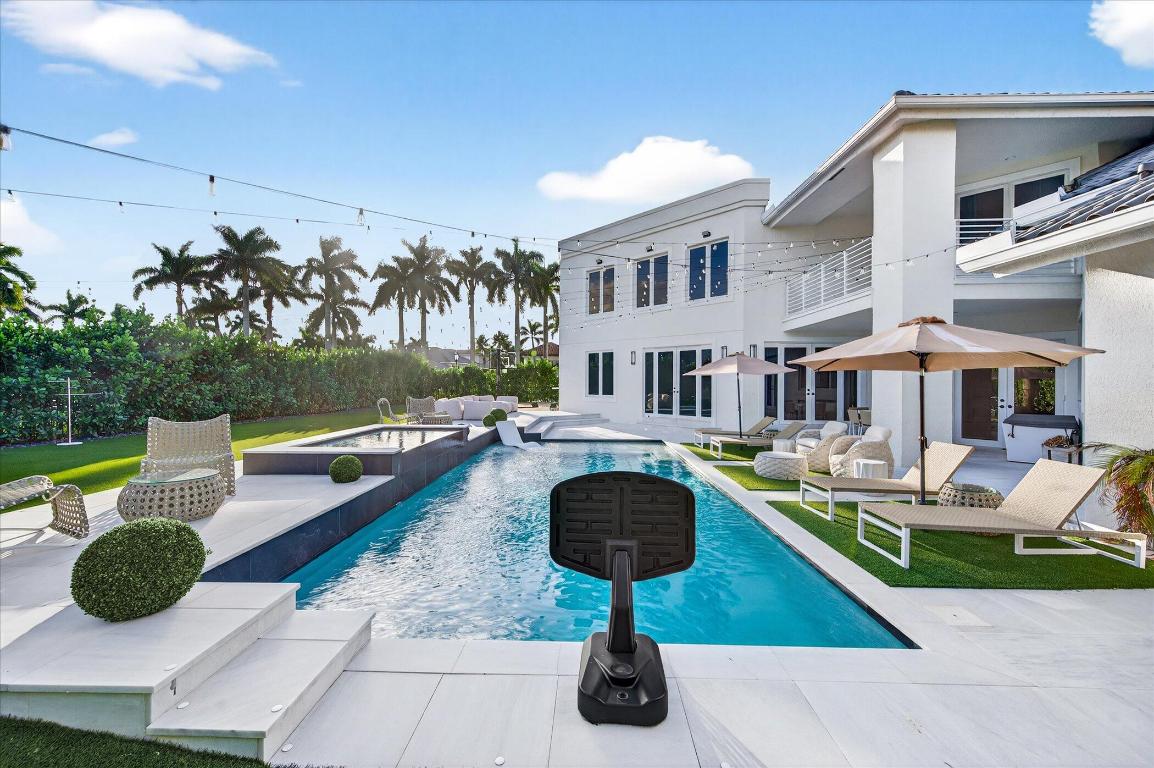 Perfectly positioned on a south-facing half-acre lot in Devon Place at Woodfield Country Club, this fully gut-renovated estate offers 7,130 SF under air of turnkey luxury living. The home features 7 bedrooms, 7.5 bathrooms, and a full 3-car garage, thoughtfully redesigned with modern finishes and infrastructure throughout. The primary suite includes three walk-in closets and dual ensuite bathrooms. Additional upgrades include impact glass. The brand-new backyard delivers resort-style living with a new pool and spa, turf, and a private sport court. A rare opportunity to own a move-in-ready, renovated estate in one of Woodfield's most desirable enclaves.All square footage figures under air are based on measurements provided by an independent 3rd party and offered for informational purposes.