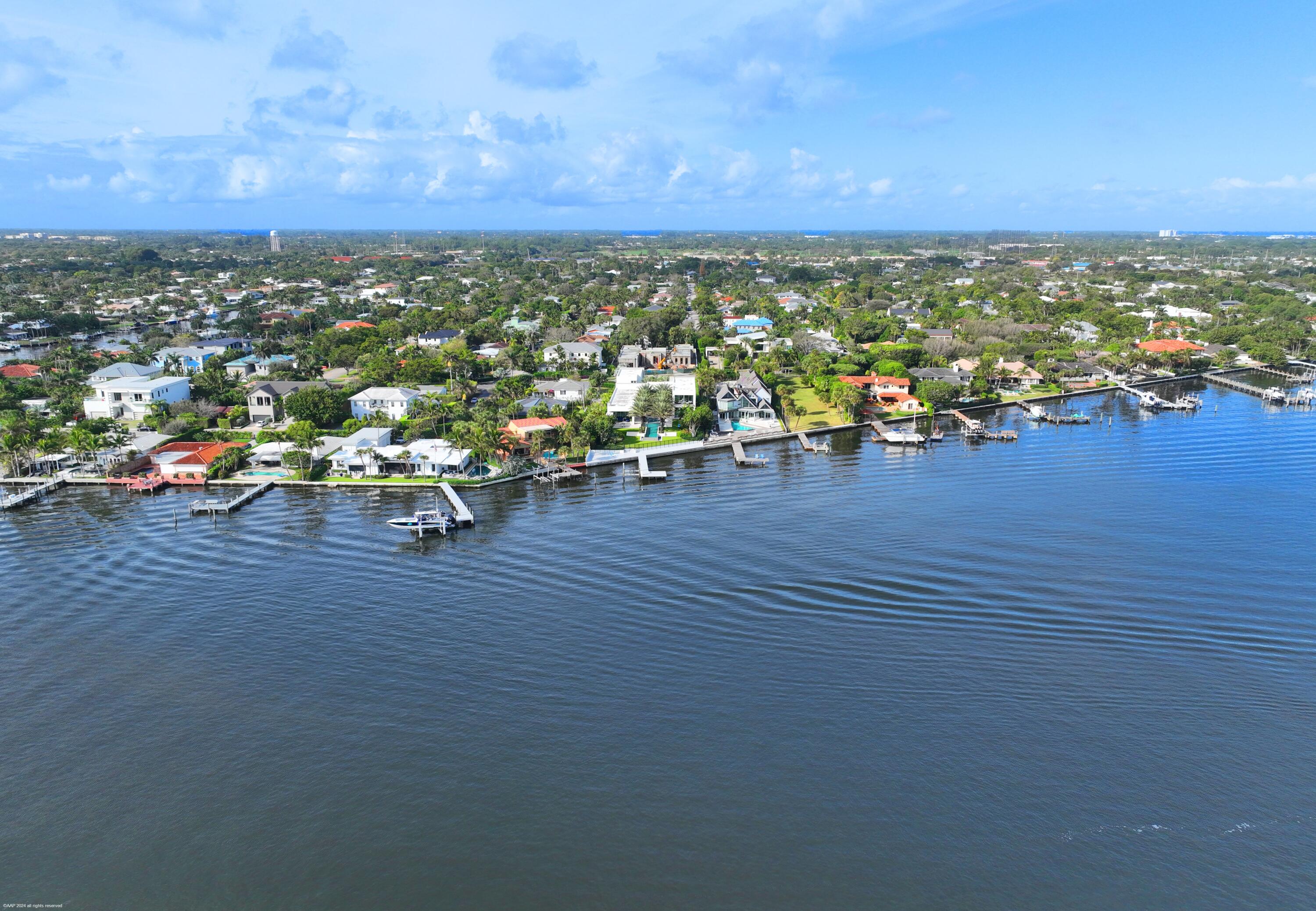From the moment you enter the gates of this massive direct Intracoastal waterfront estate, you will experience first hand the hundreds of hours of creative design by famed and respected architect George Brewer. His vision coupled with the direction and inspiration from the owners' decades of world travels have created this stunning modern masterpiece that was completed in 2021.
Water is the main focus as you experience it throughout this nearly one acre property. From the front entrance and its cascading fountains, to the walls of glass that frame the entire eastern elevation of the home showcasing the massive resort style pool and turfed courtyard including a unique acrylic heated spa actually sitting in the water, to the expansive Intracoastal waterfront that has one of the largest, if not the largest, over the water deck and boat docks in SoSo.  This provides the most spectacular long water views of downtown West Palm Beach you'll experience. 
The primary suite overlooks all this incredible beauty boasting a Worth Avenue boutique sized closet and a bath that lacks nothing.
The SOTArt gourmet kitchen has two huge islands and is loaded with everything needed to entertain family, friends and guests.
The fabulous design includes an elevator, an office, a warehouse sized refrigerated wine cooler, a very gracious and private guest apartment, an oversized 3 car garage, an outdoor kitchen and incredible covered outdoor dining and relaxation spaces. Finally, the decorative paved auto courtyard has room for over 20 cars. Seller is replacing chandelier with a like-kind chandelier prior to the closing.