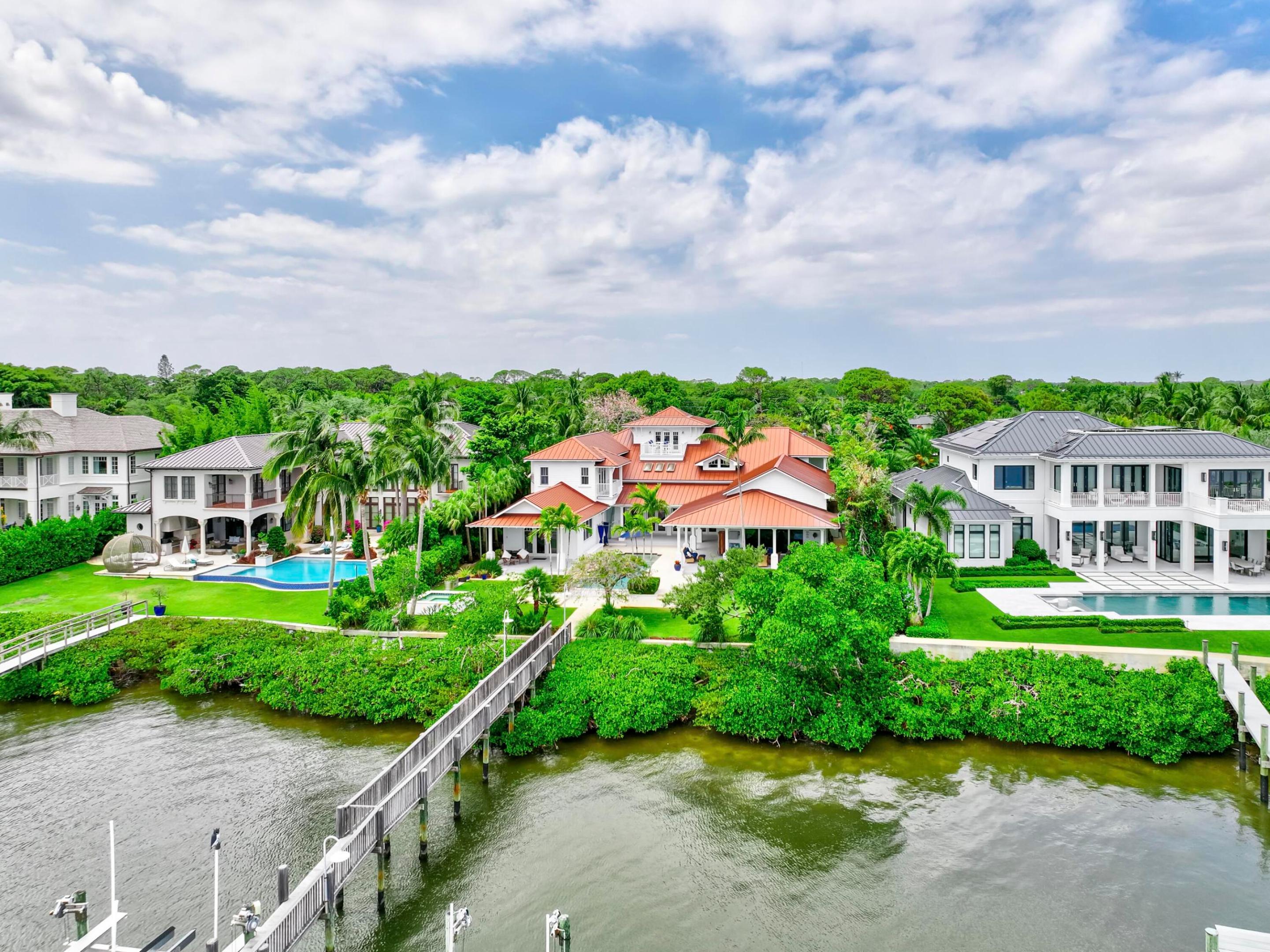 Exclusive waterfront living. Live like a pro in this luxurious waterfront home.
 Welcome to your dream escape! This stunning furnished home on the Loxahatchee River in picturesque Jupiter, Florida, is the epitome of coastal elegance and charm. Designed with a light and bright ambiance, this residence offers an inviting blend of sophistication and relaxation, perfect for those seeking a serene retreat.
Step inside to discover elegant, coastal-inspired interiors featuring open-concept living spaces with wide panoramic 1 mile views of the sparkling river. Expansive windows flood the home with natural light, showcasing the breathtaking scenery and creating a seamless indoor-outdoor flow. The thoughtfully curated furnishings exude modern coastal charm, with soft neutral tones, natural textures, and subtle pops of seaside blues and greens. The fully equipped chef's kitchen boasts top-of-the-line appliances and ample space for entertaining, while the living and dining areas open to spacious outdoor terraces where you can soak in the tranquil river vistas.
Unwind in the luxurious primary suite, complete with private, old world style back porch overlooking the river with a spa-inspired ensuite bath. Additional guest rooms provide comfort and privacy, each beautifully appointed for your guests' enjoyment. Your family and guests will spend endless hours in the nicely equipped billiard and game room.
Outside, the property offers direct water access, perfect for boating, paddleboarding, or simply enjoying the peaceful setting. Lounge on the sun-drenched deck, entertain by the waterfront, or take in the evening sunset from 2 private docks, one which accommodates a vessel size up to 40 ft and 20,000 pounds with a 3 ft draw at high tide, the smaller lift holds up to 10,000 pounds and a 24-foot boat. Enjoy the sweeping views of the Loxahatchee River that extend over a mile to the Jupiter Lighthouse.
Conveniently located near Jupiter's best dining, shopping, and beaches, this luxurious rental is a true gem, offering the perfect blend of relaxation and lifestyle.
 Nestled on nearly an acre lot, this 5-bedroom, 7-bath masterpiece offers everything you need to live, entertain, and relax in style.
This 3-story Florida Cracker-style home, designed to modern specifications, boasts an end-of-point location facing SSE, ensuring refreshing summer breezes and breathtaking, mile-long views of the Loxahatchee River.
Property Highlights:
" Elevator for seamless access to second floor
" 3rd-floor widow's walk with panoramic views 
" Anderson windows providing abundant natural light
" Gipcrete layer between floors for added comfort and privacy
" 4-car air-conditioned garage
" Game room with billiards table for entertainment
" Adequate space for a hitting bay in garage for the enthusiast
"       Complete gym with pull-up bar, treadmill, rogue bike and a 
         rower
"        Putting Green
"        Firepit
Outdoor living is redefined with ample space for enjoying the waterfront setting, all while being surrounded by the beauty of Pennock Point. This home offers the perfect balance of coastal charm and modern luxury.
Schedule your private tour today and step into the lifestyle you've been dreaming of!