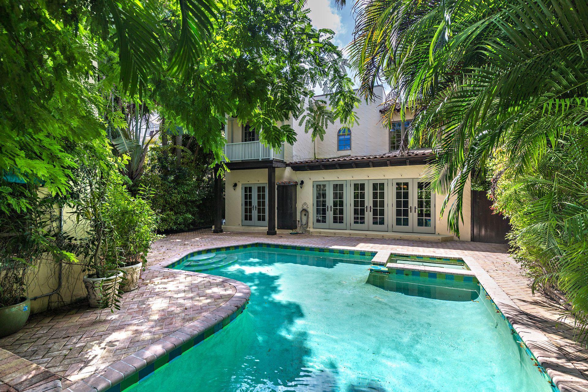 Located two properties from the Ocean, this gracious home offers three bedrooms, two and a half bathrooms in the main residence with a separate two-story guest cottage and pool. Vernacular butterfly gardens flank the exterior of the property, accentuating the iconic architecture of the 1920s home. Greeted by a formal foyer and sweeping staircase, the interior boasts living spaces wrapped in oversized windows and natural light, and features original details throughout the thoughtful floor plan. The rear patio & pool offer private entertaining spaces overlooking the highly desirable separate cottage, perfect for virtual conference space or guests. The Midtown location is ideally positioned in the heart of the Island and offers easy access to all restaurants, shopping, beaches, and houses of Worship.