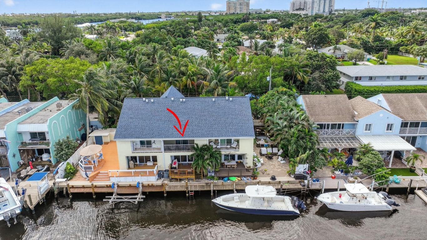 True waterfront living in this beautifully renovated 2-bedroom, 2.5-bath intracoastal townhome featuring a deeded boat slip and 20 feet of private dock space. With no HOA and no fixed bridges, this rare property offers effortless access to the open ocean—just steps from your back door.

Step inside to find a beautifully renovated interior (2019) showcasing travertine floors, crown molding, and coastal-inspired finishes. The kitchen is both stylish and functional, featuring solid wood cabinetry, granite countertops, a subway tile backsplash, and stainless steel Whirlpool appliances. French doors open to a charming front porch, perfect for grilling or dining al fresco, while the spacious living room extends to a covered patio overlooking the canal and your private boat slip ideal for relaxing or entertaining. Recent upgrades include a new roof (2017), hurricane-impact windows and doors, and a Trane A/C system (2022) for comfort and peace of mind. Perfectly situated less than half a mile from the Boynton Beach Inlet, you'll enjoy direct ocean access and short boat rides to favorite waterfront destinations like Beer Can Island, Banana Boat, Two Georges, and Deck 84. Nestled on a quiet private road, the property is surrounded by lush tropical landscaping, privacy hedges, and features an oversized driveway with ample parkinga perfect blend of luxury, leisure, and coastal charm. With no HOA restrictions, there are no rental, parking, or pet limitations, making this an exceptional opportunity for investors seeking short-term or annual rental income as well as those looking for a private coastal retreat.