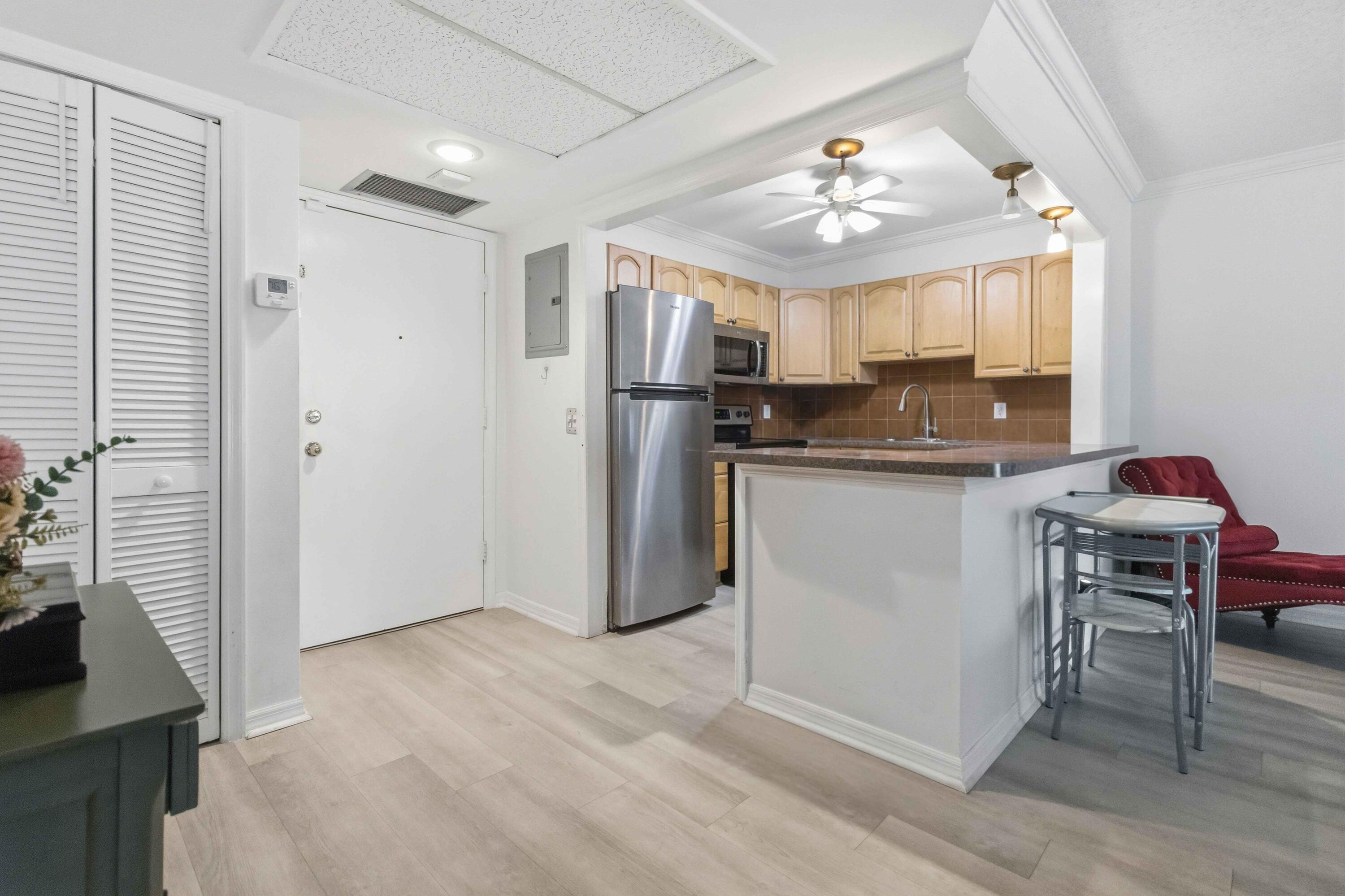 Resort-style living just moments from the shoreline—this beautifully updated 1-bedroom residence is ideally situated only 2 miles from Pompano Beach. The interior features sleek laminate flooring throughout, complemented by a thoughtfully renovated kitchen and bathroom with modern finishes and newer appliances.  Residents enjoy a secure lobby with call-box entry, along with an impressive array of amenities including a heated pool, tennis courts, sauna, library, BBQ area, and an inviting entertainment lounge with billiards. Perfectly positioned near shopping, local conveniences, and directly across from the Pompano Beach Cultural Center, this location offers both accessibility and lifestyle appeal.  Just minutes from the beach and iconic pier, this is South Florida living at its finest.
