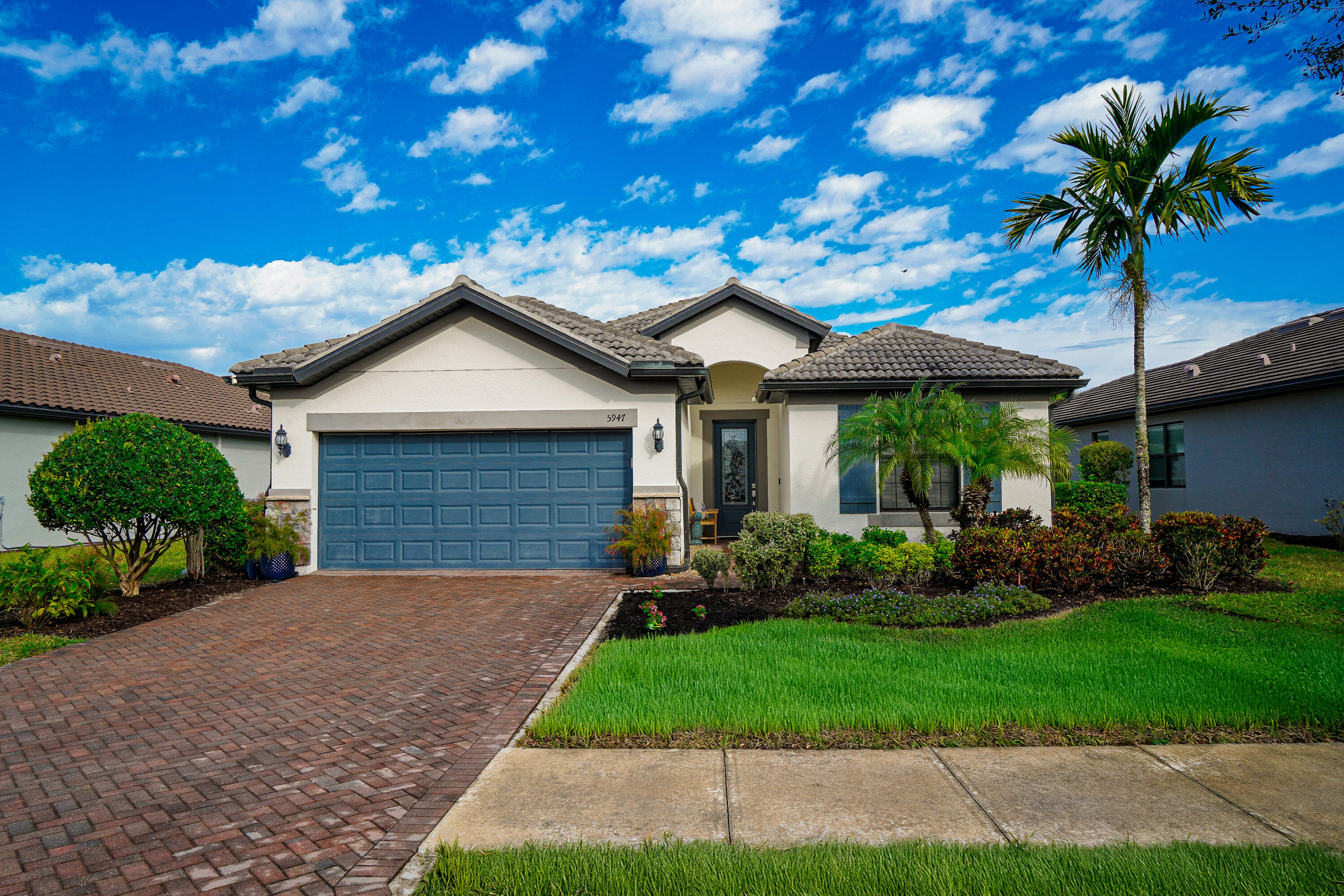 Enter this exceptional Summerwood model through the leaded-glass front door into a stunning wide foyer, where numerous upgrades create a light and airy atmosphere. Diagonally laid tile flows seamlessly throughout the entire home and is complemented by elegant crown molding in every room and hallway. The spacious living area features 90-degree pocketing sliders, offering true indoor-outdoor Florida living, and opens to an expansive lanai with peaceful pond views and a beautiful array of tropical birds. The upgraded kitchen is both stylish and functional, featuring a long island that seats four, cabinetry on both ends, a sleek slide-in stove, and ample storage with convenient pull-out lower drawers. The master suite boasts a designer tray ceiling and serene pond views, while the elegant en- suite bath includes double sinks and a large Roman shower. The front bedroom offers a built-in Murphy bed with two bookcases, a built-in laptop drawer, and two file drawers. The den is versatile and can easily be used as a bedroom or office, featuring elegant French doors. Additional highlights include impact-resistant doors and windows for security and energy efficiency, and a tandem garage that accommodates two cars and a golf cart or two vehicles and a workshop, with pull-down attic stairs for additional storage. This home is within walking distance to both clubhouses and the Rusty Putter Restaurant, and the community offers extensive amenities including 12 pickleball courts, two tennis courts, four bocce ball courts, a resort-style heated pool, lap pool, spa, fitness center, sauna, fitness classes,library, hair salon,  an 18-hole par-72 golf course, golf simulator, driving and putting range, garden plots, and numerous clubs and activities. Ave Maria also hosts seasonal festivals and a winter farmers' market, making this an exceptional place to live and play. HOA cover high speed internet and cable with a lot of stations. The HOA also pays for your landscaping maintenance and sprinklers.