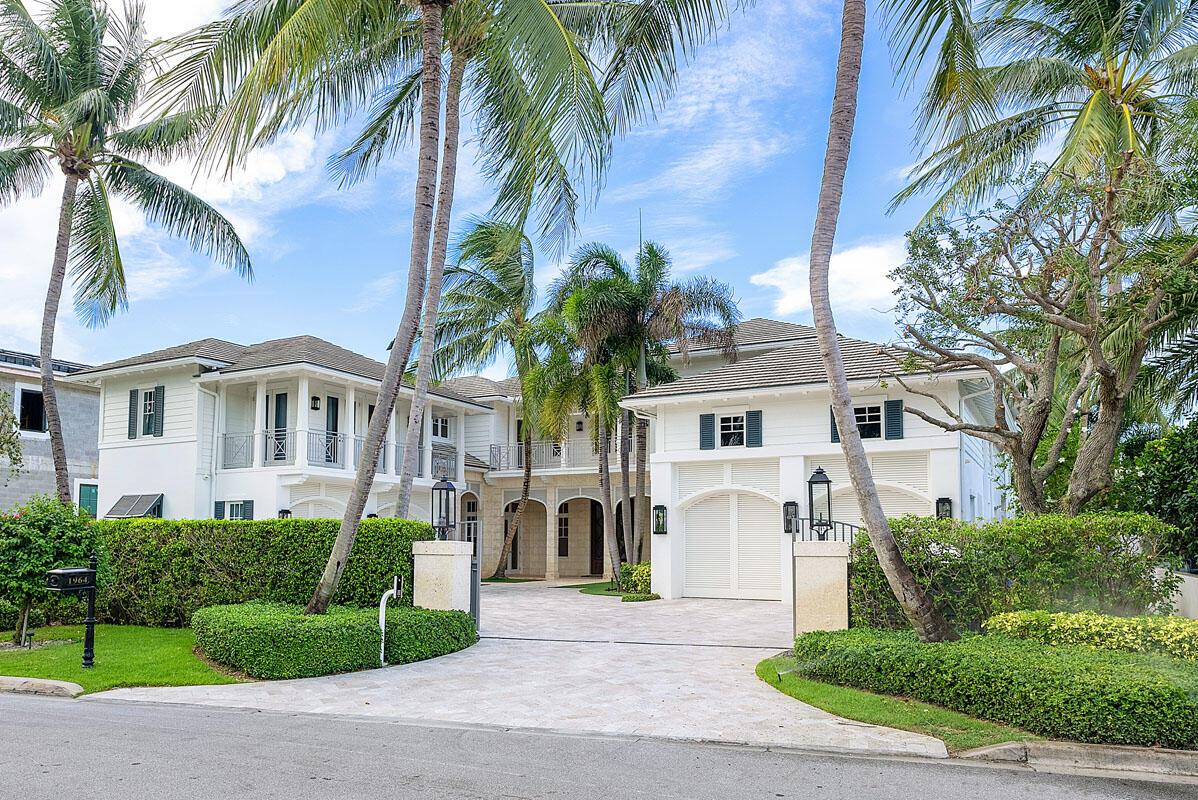 Welcome to 1964 Royal Palm Way, an exquisite estate on an oversized Intracoastal property, offering an impressive 100' water frontage within the prestigious Royal Palm Yacht & Country Club. This exceptional British West Indies home is a one-of-a-kind paradise spanning over 10,000 square feet of luxurious living space. The opulent interior boasts beautiful marble and Brazilian hardwood floors, exquisitely crafted woodwork, six bedrooms suites, and thoughtfully designed custom architectural features that exemplify sophistication and attention to detail. 
Step outside to your resort-like oasis in the backyard, a haven of relaxation and entertainment. The heated freestyle infinity-edge pool beckons with its enticing design, accompanied by a massive spa, water sprays, and a sun shelf... for blissful lounging. An inset circular firepit lounge invites cozy gatherings and adds a touch of magic to the outdoor setting. 

Discover the epitome of luxury living, where elegance, comfort, and scenic beauty merge to create an extraordinary lifestyle. This exclusive estate promises an unparalleled experience for those seeking the finest waterfront living and indulgent amenities.