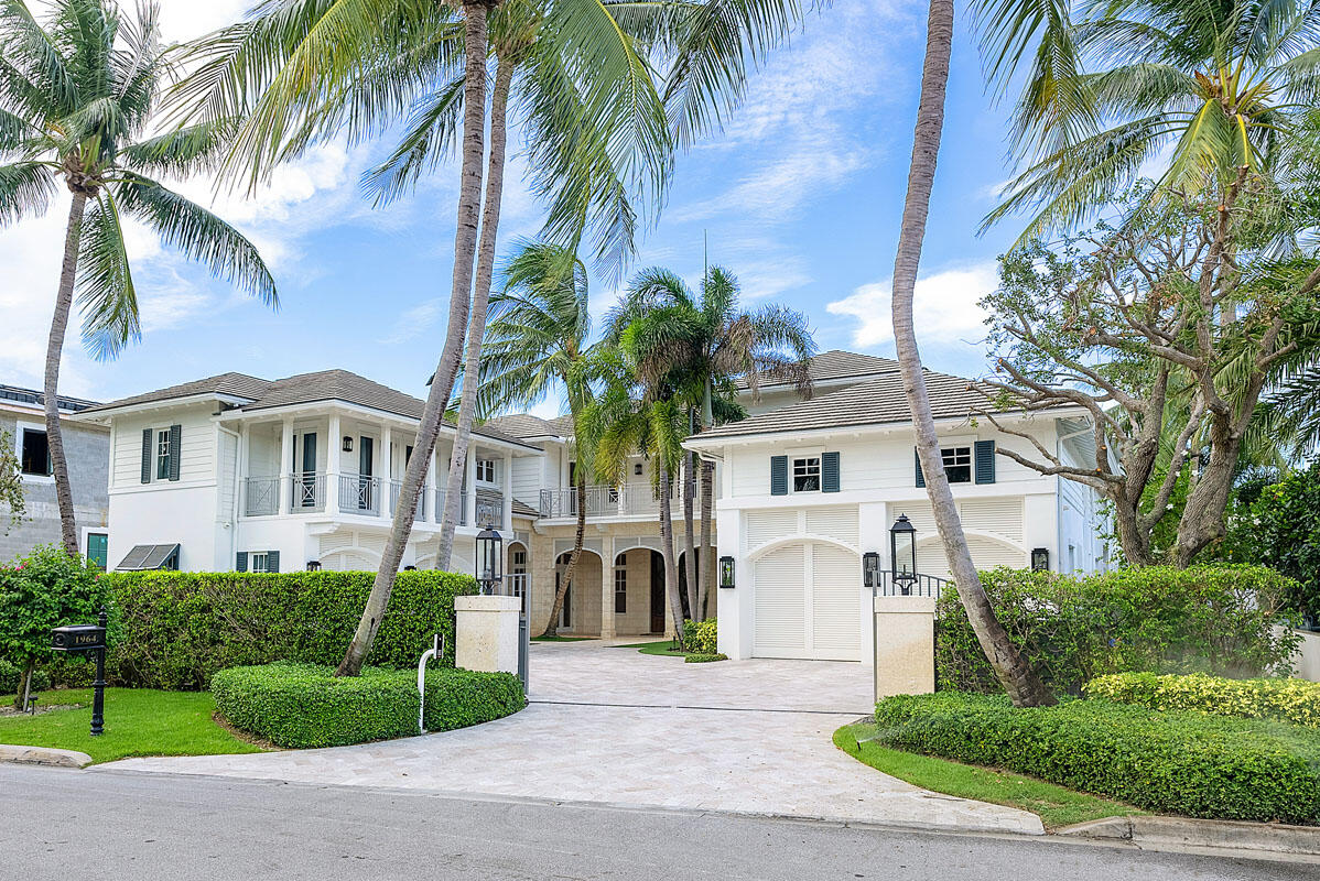 Welcome to 1964 Royal Palm Way, an exquisite estate on an oversized Intracoastal property, offering an impressive 100' water frontage within the prestigious Royal Palm Yacht & Country Club. This exceptional British West Indies home is a one-of-a-kind paradise spanning over 10,000 square feet of luxurious living space. The opulent interior boasts beautiful marble and Brazilian hardwood floors, exquisitely crafted woodwork, six bedrooms suites, and thoughtfully designed custom architectural features that exemplify sophistication and attention to detail. 
Step outside to your resort-like oasis in the backyard, a haven of relaxation and entertainment. The heated freestyle infinity-edge pool beckons with its enticing design, accompanied by a massive spa, water sprays, and a sun shelf... for blissful lounging. An inset circular firepit lounge invites cozy gatherings and adds a touch of magic to the outdoor setting. 

Discover the epitome of luxury living, where elegance, comfort, and scenic beauty merge to create an extraordinary lifestyle. This exclusive estate promises an unparalleled experience for those seeking the finest waterfront living and indulgent amenities.