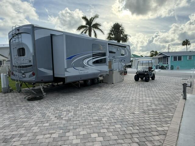 Build your Island Oasis on Hutchinson Island! Discover this rare vacant lot at 883 Nettles Blvd  in the exclusive, guard-gated Nettles Island community on Hutchinson Island, Jensen Beach, FL. This prime parcel offers the perfect canvas to create your dream coastal retreat or savvy investment property in one of the Treasure Coast's most desirable resort-style condo golf cart community. Enjoy direct access to pristine private beaches, two heated swimming pools, hot tubs, tennis, pickleball, bocce, marina with boat slips, fitness center, clubhouse with  over 40 social clubs and events, mini golf, 1 mile from golf course, on-site restaurants, snack bar, market, and more.  Perfect for building your dream coastal getaway or investment property in this vibrant, amenity-rich condo-style community. Note:  An RV is currently on the property for the seller's personal use.  It does not convey with the lot but is available for separate purchase directly from the Seller if interested. Whether you are envisioning  a custom home, vacation getaway, or rental property, this lot in the heart of Nettles Island puts you in the middle of endless recreation, relaxation, and community fun.  Live every day like you are on a permanent  vacation! Reach out for more details, building requirements, pricing on the optional RV, and to schedule a showing.