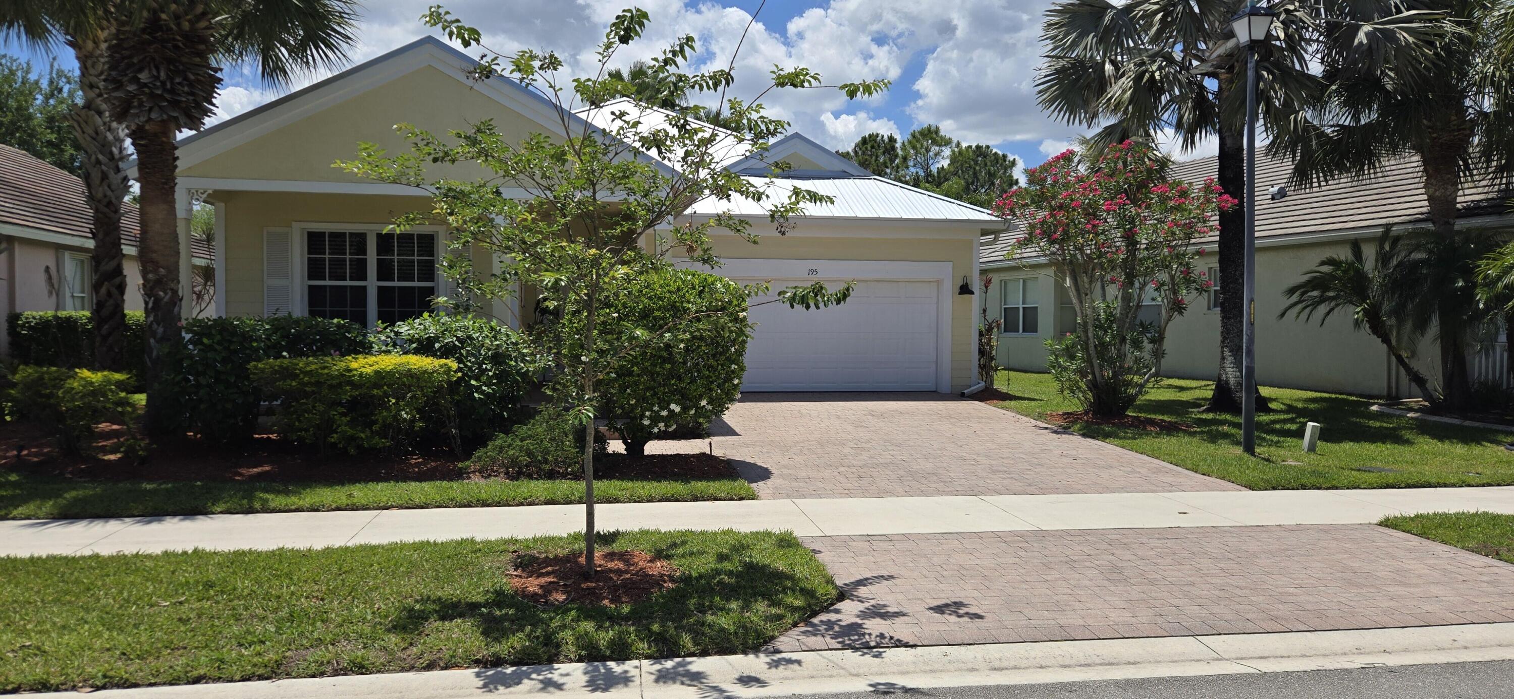 Welcome to 195 NW Willow Grove Avenue. As you approach this Key West style home, you are greeted with a cheerful yellow exterior, accented by Hardie board siding, decorative shutters, and a spacious covered front porch. With 3 bedrooms, 2 bathrooms, formal dining room, family room, breakfast nook, and screened-in lanai, there is plenty of places for the family to gather. The light and bright kitchen boasts 42-inch cabinets, decorative backsplash, pantry, eat-in bar, and breakfast nook. The primary suite has tray ceilings, room for a sitting area, 2 large closets, and an ensuite bathroom with a soaking tub, separate shower, and dual vanities. New metal roof 2026, AC 2022 , Hot water 2021, new carpets in 2 bedrooms, and a new floor in primary bathroom.