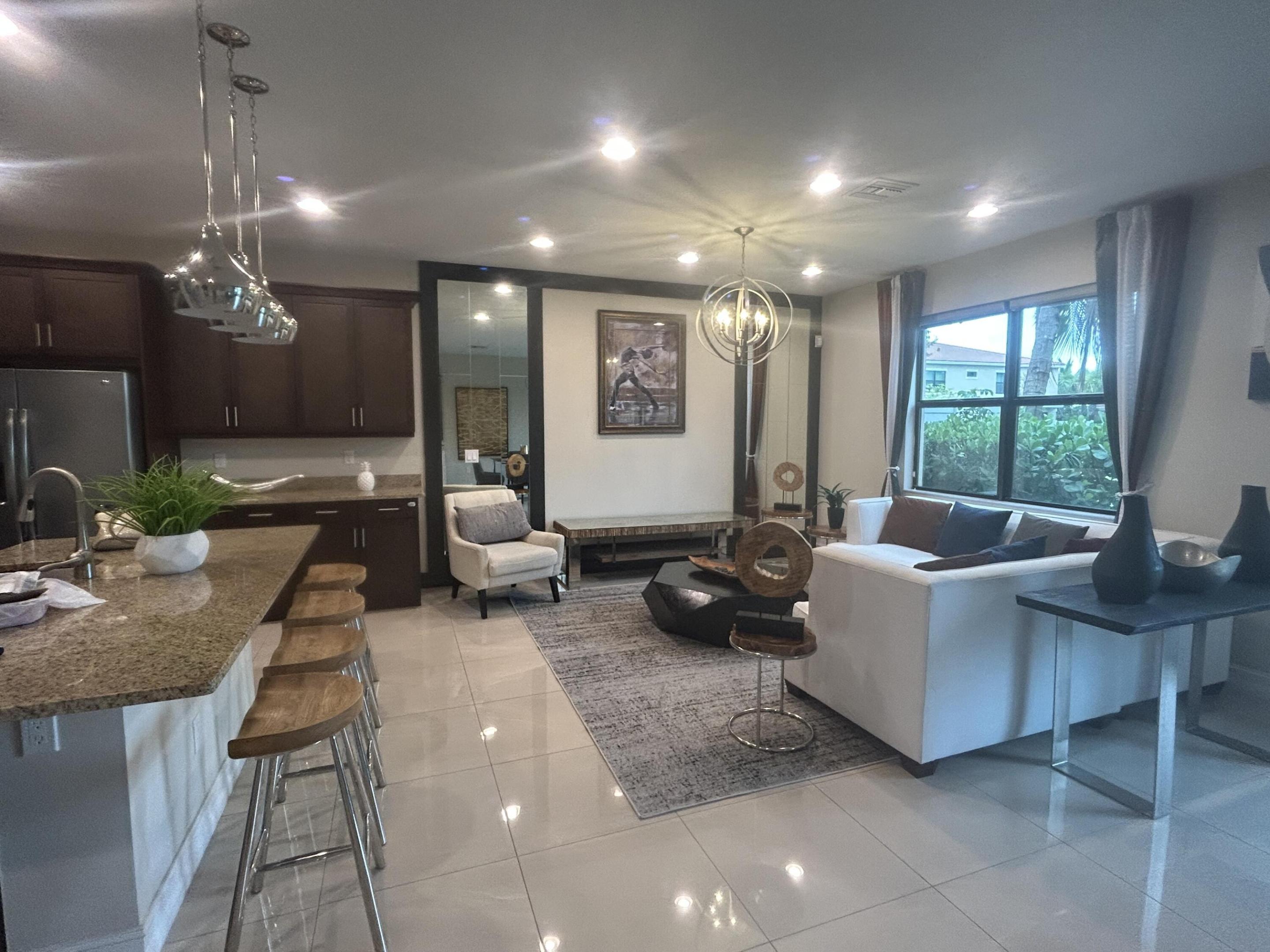 Luxury townhome in Boca Raton built in 2019 located in the gated Enclave of Boca Dunes. Spacious, private end-unit features 2020 sq ft of living space. This unit is a former 'builders model'. Gourmet kitchen with cook island & double ovens. Custom window treatments throughout to include blackout shades. Oversized owners suite with huge walk-in closet, spa bath and water views. Versatile loft space ideal for media room. Alarm system. Complete hurricane windows & doors. Convenient upstairs laundry room. Serene lake views from private patio. Resort-style amenities include clubhouse, pool, spa, fitness center, billiards & children's play area. A rated schools. Offered fully furnished, 12 month annual lease only. $200.00 application/background on all occupants 18 years or older payable to: Boca Dunes Homeowners Association. $200.00 processing fee to GRS Community Management