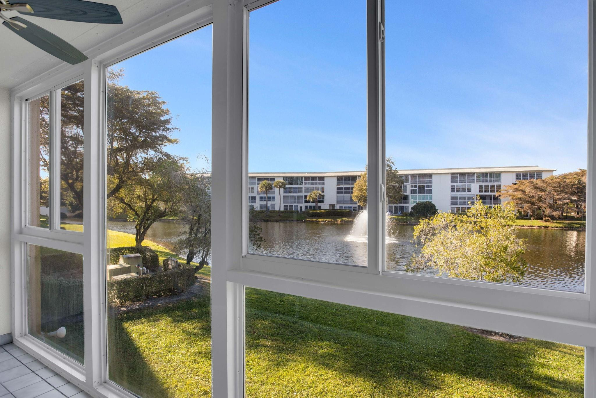 This property features all-waterproof laminate flooring and an in-unit washer and dryer, and it has been professionally cleaned. It includes an impact glass enclosure valued at $14,000. The air conditioning unit was installed in 2022, and the water heater was replaced in 2017. Enjoy outstanding panoramic water views with a fountain. Please see all the photos and come see it for yourself! There is ample parking for guests. The kitchen has been updated.