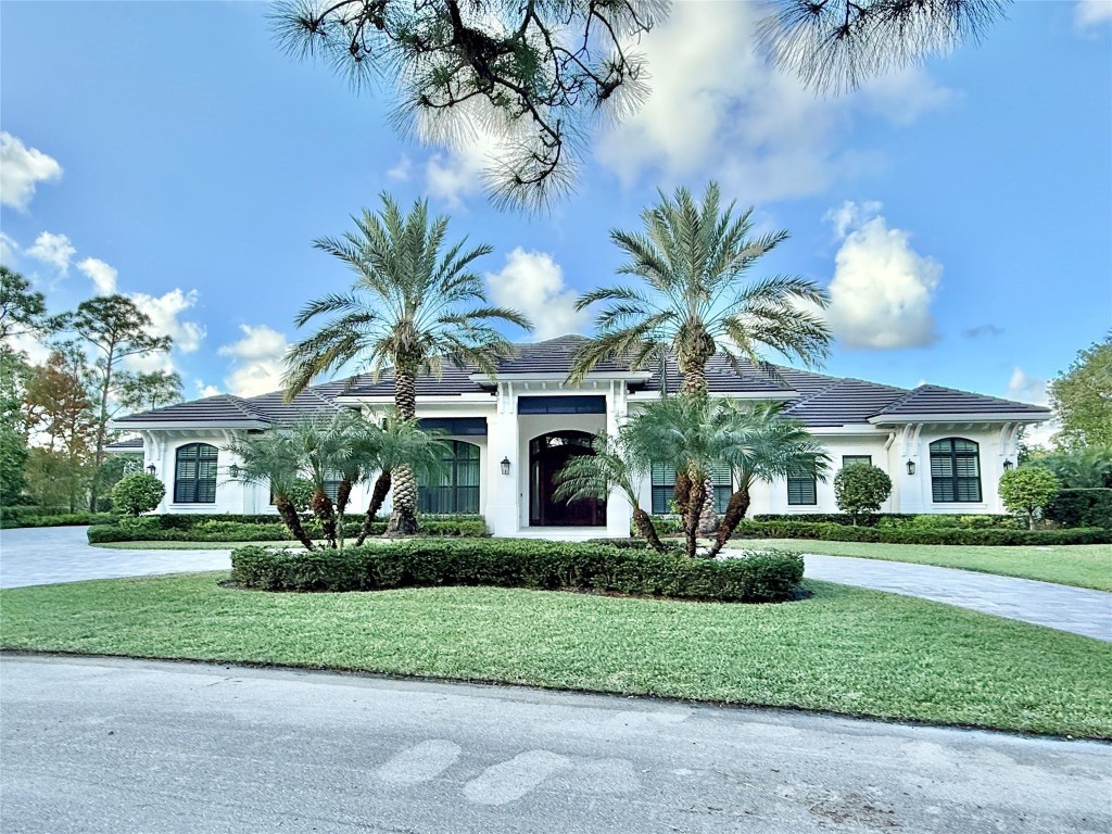 This elegant one-level residence offering 5,705 square feet under air captures serene views of the golf course and surrounding preserve, creating a truly peaceful setting. Thoughtfully designed for both comfort and entertaining, the home features four bedrooms, five full baths, a half bath, plus a convenient cabana bath, all seamlessly arranged on a single level. Refined custom woodworking and architectural details enhance the interior with timeless craftsmanship and warmth. Outdoor living is elevated by a free-form pool surrounded by lush landscaping, ideal for both relaxation and entertaining. A circular driveway adds impressive curb appeal and ease of arrival. Situated on .69 acres and offered partially furnished, this exceptional property offers privacy, elegance, and luxury.