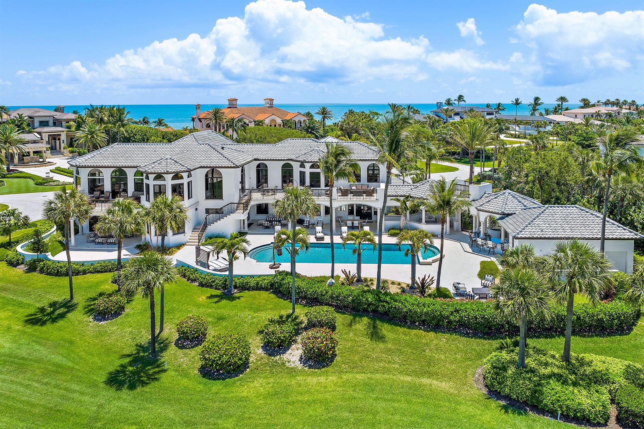 Exquisite modern home on best golf course lot in Sailfish Point & designed to maximize panoramic views of the Ocean & 18th fairway & green of Jack Nicklaus Signature golf course from every room. Each level provides ample space for family or guests with bedrooms, living area, kitchen and laundry on each floor. Living/entertaining area extends outdoors to large balconies & covered patios w/summer kitchen, expansive pool deck, 48 ft pool, 2 spas, firepit & separate guest house. Private community offering residents world-class amenities: beachfront clubhouse, optional golf, tennis, pickleball, marina/immediate ocean access & low rates, 5 restaurants, fitness center, spa/salon, private security & friendly, active lifestyle minutes from private airport w/US Customs. Hi-speed rail station coming