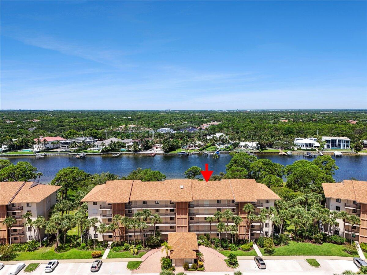 Waterfront sunsets, passing boats, and coastal breezes await from this furnished, turnkey 4th-floor residence in The Marina at The Bluffs. This spacious 2BR/2BA condo features Intracoastal views from the living areas and primary suite, plus two screened balconies perfect for enjoying spectacular west-facing sunsets. The open floor plan offers comfortable living with elevator access and assigned parking. Community amenities include a waterfront pool, tennis, pickleball, bocce ball, and beautifully maintained grounds. Watch Jupiter's famous Holiday Boat Parade each December. Minutes to Jupiter Beach, waterfront dining, shopping, golf, marinas, and parks. Wi-Fi and cable included. Available with a 4-month minimum lease; longer-term rentals considered.