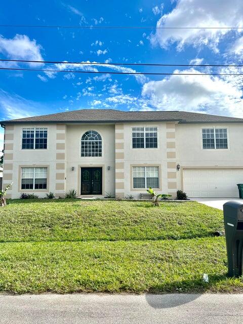 This Beautiful 5 Bedroom/2.5 Bathroom, 2 story home, with a screened patio is a must see! Has a Loft upstairs, and extra room downstairs, Water Heater replaced in 2020, 2024 A/C unit (One upstairs and there is another one downstairs) . Tile throughout, huge fenced backyard....Close to shopping, I-95 and Turnpike.