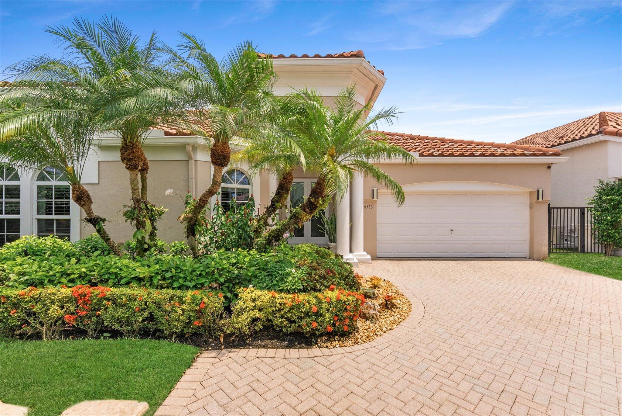 Nestled within the prestigious Woodfield Country Club, this beautiful residence offers 3 BR's plus den, 2.1 BA's, and 3,086 living  sq ft of light-filled living space. Designed for both comfort and entertaining, the home features soaring natural light, expansive sliding glass doors, and seamless views of the private pool and outdoor living areas.  Recent upgrades include impact windows and doors, two brand-new air conditioning systems, freshly painted interiors, and beautifully renovated bathrooms. The luxurious primary suite serves as a private retreat, complete with a spa-inspired bath featuring a steam shower, Jacuzzi tub, and custom-designed walk-in closets. The heart of the home opens effortlessly to the outdoor entertaining space, where a sparkling pool, Italian pizza oven, and lush  surroundings create the perfect setting for gatherings with family and friends. Additional highlights include a fireplace, built-in wine refrigerator, custom bar with ice maker, and a beautifully updated two-car garage.  Beyond the home, residents enjoy the unparalleled Woodfield Country Club lifestyle, renowned for its championship golf course, world-class tennis and pickleball facilities, resort-style pool, state-of-the-art fitness center, exceptional dining venues, and a vibrant year-round social calendar. Offering luxury, recreation, and an unmatched sense of community, Woodfield is one of Boca Raton's most coveted private club communities.
