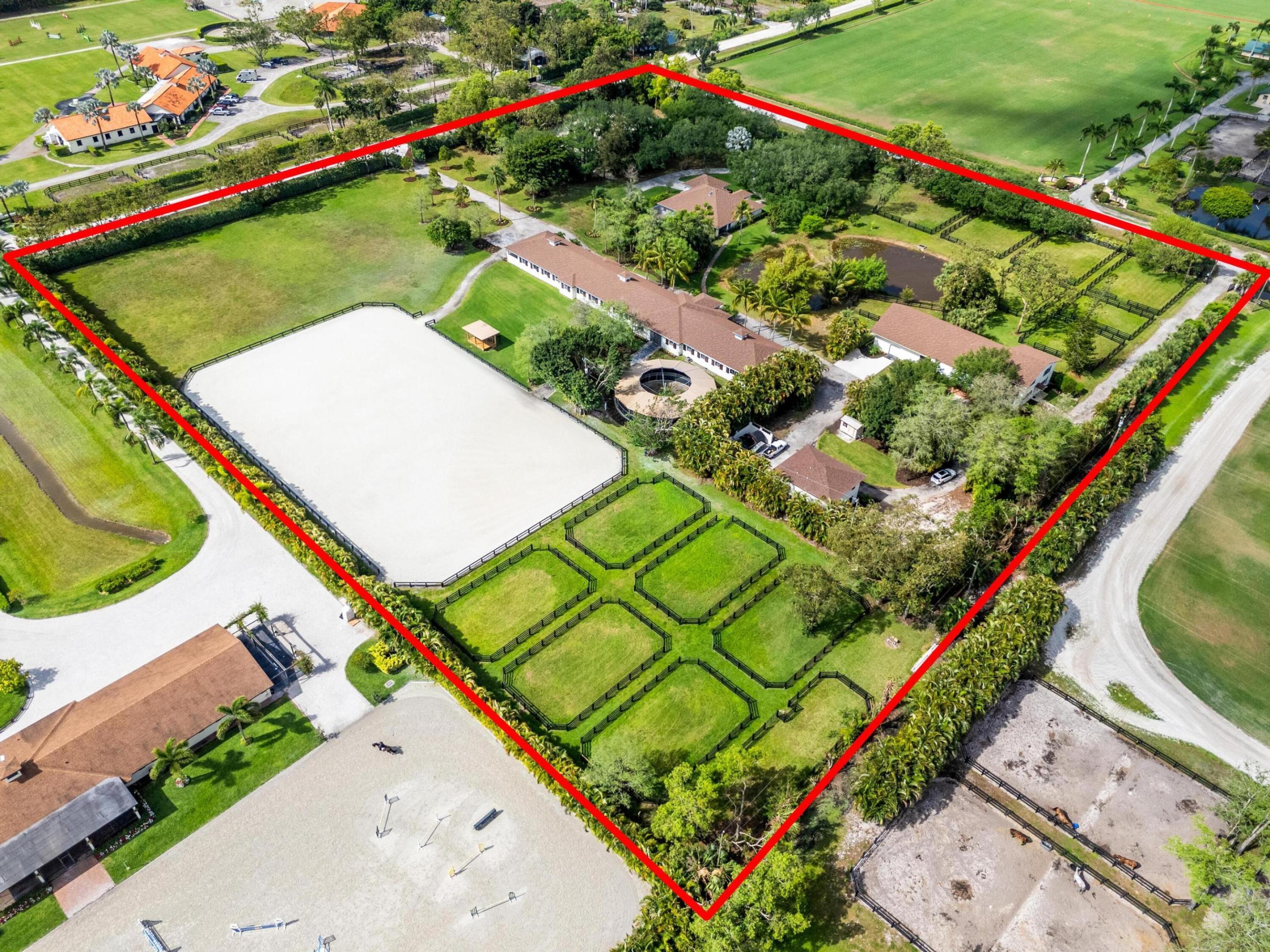 Enjoy the best of both worlds on this exceptional 10+-acre equestrian property, ideally located just minutes from Global and WEF while offering the tranquility of Wellington's farm life. This property combines top-tier equestrian amenities with luxurious living, providing everything needed for you and your horses. The 26-stall center-aisle barn is the standout feature of this property, equipped with 6 wash stalls, 2 tack rooms, a feed room, and a lounge. A separate building offers even more versatility, with a second lounge, 2 bathrooms, an oversized laundry room, and 2 spacious 2-bedroom, 1-bathroom apartments. Additionally, a huge storage area provides ample space for hay, shavings, tractors, golf carts, jumps, and farm equipment. Other equestrian facilities include 2 all weather arenas a large grass riding field, a 6-horse covered hotwalker, and 15 paddocks, all designed to support training, turn-out, and leisure riding. The property features two beautiful homes. The original 4-bedroom, 3-bathroom single-story home has been recently remodeled throughout, offering wood and tile floors, a beautiful kitchen with all new appliances, and a screened-in patio with a heated pool and jacuzzi for relaxing. The second residence is a newly constructed 2-story, 4-bedroom, 3-bathroom home with modern finishes, ideal for a property manager or staff. Privacy and convenience are essential, with 1 private entrance for the original home and 2 separate entrances for the barn, allowing easy access. The estate is surrounded by lush landscaping, including a clusia hedge and tropical palms, offering both beauty and privacy. Recent updates include brand-new roofs on all structures, a new water filtration system and newer AC units throughout. This property offers the ideal blend of luxury, functionality, and location, making it the perfect place to live, train, and enjoy the equestrian lifestyle.  List of improvements with current owner -Replaced ALL the roofs on all structures (barn, house, storage building) -Added an oversized arena approximately 150' x 250' -Replaced the footing in both arenas (ESI) -Added a 6 horse hotwalker -Added an additional 8 stalls and refaced all stalls -Added one additional tackroom and 2 additional wash stalls -Added paddocks (total of 15) -Replaced the AC units and Hot water heaters -Added an additional septic system -Added a new well -Replaced the water system servicing the house and barn -Completely updated/remodeled the original house -Built a brand new two story 4 bedroom 3 bath house -Updated the 2 staff apartments both 2 bedroom 1 bath -Added a laundry room for the barn -Added a second lounge with a full bathroom -Added a 3rd automatic gate off 57th Place -Replaced the pool heater, screening around the pool and leveled the pavers -Added a Clusia hedge along the front and side of the property for additional privacy -Added a coved viewing deck along the larger arena