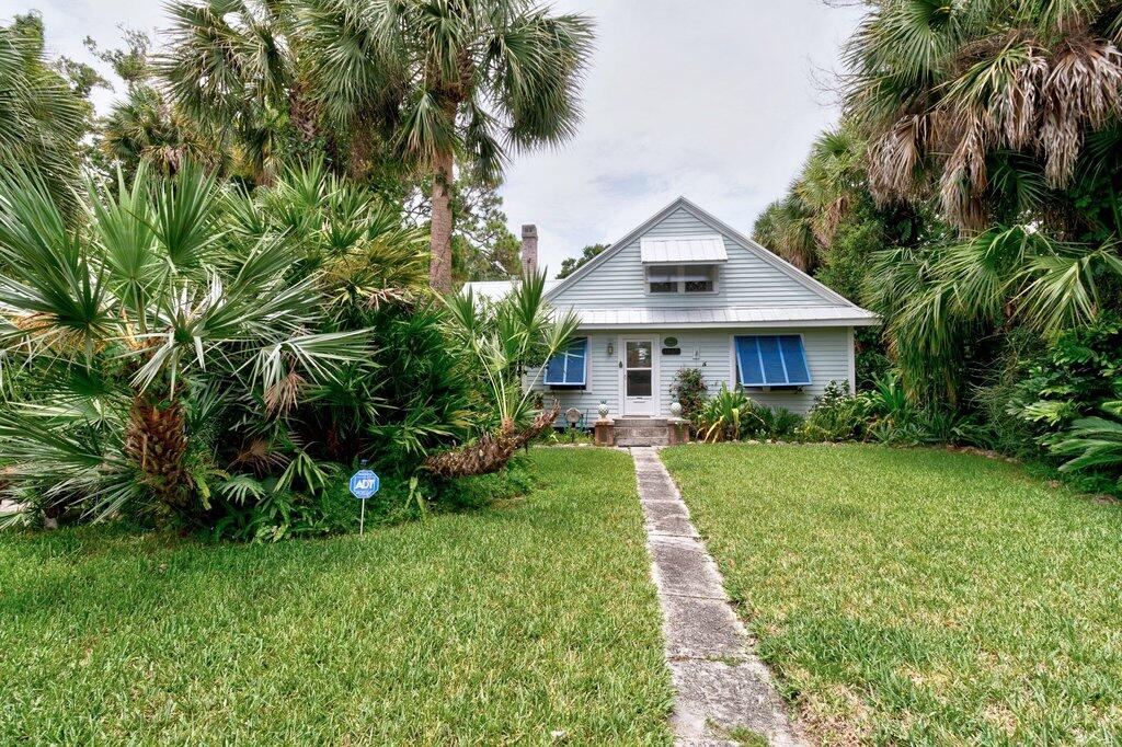 Imagine yourself in this rare naturally historic 1929 Old Florida-style home; .57 acres nestled beneath a canopy of mature tropical foliage in one of Vero's most charming & sought-after downtown neighborhoods. This enchanting cottage seamlessly blends timeless character and classic Florida charm. Original architectural details combined with your reimagined space will create a home rich in personality while meeting the needs of today's homeowner. The outdoor sanctuary offers a tropical paradise with mature palm trees, waterfall and stream, offering exceptional privacy. A circular driveway runs the southern perimeter of the property, with plenty of room for boats & RV's or business equipment.  Upstairs offers a 2 room + bath apartment with separate entrance.  Artesian well on property.